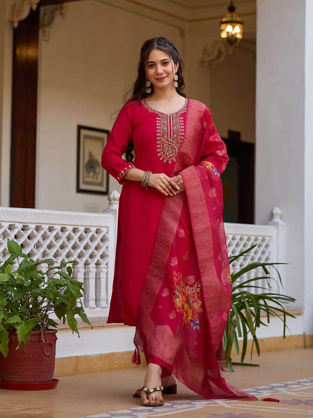 Full shot of a woman in a magenta embroidered kurti set, posing elegantly with organza dupatta.
