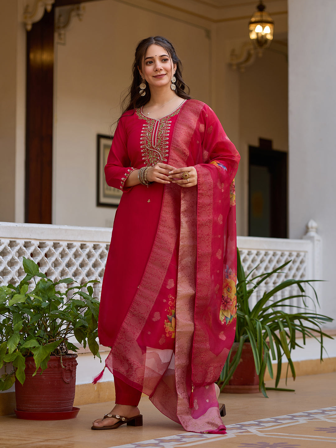 Woman showcasing the graceful flow and style of the magenta kurti, pant, and embroidered organza dupatta.