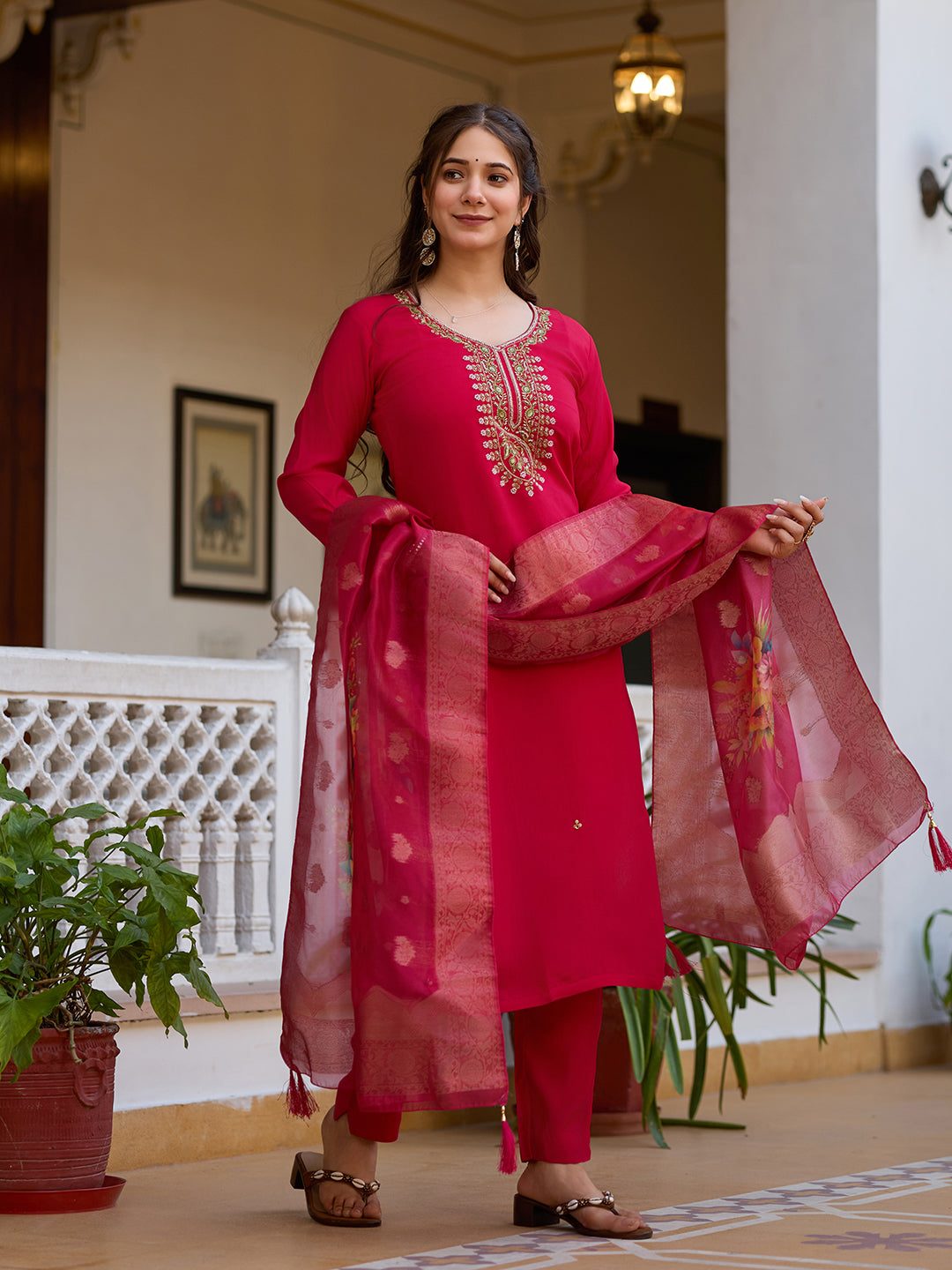 Model demonstrating the beautiful drape of the embellished organza dupatta with the magenta kurti set.
