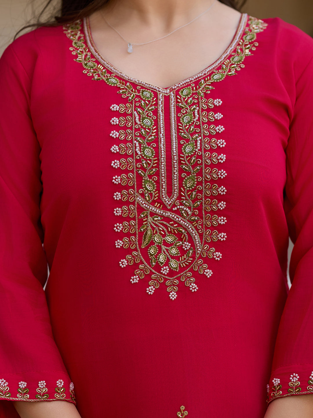 Detailed shot of the exquisite bead and thread work on the magenta Viscose Chanderi kurti's V-neckline.