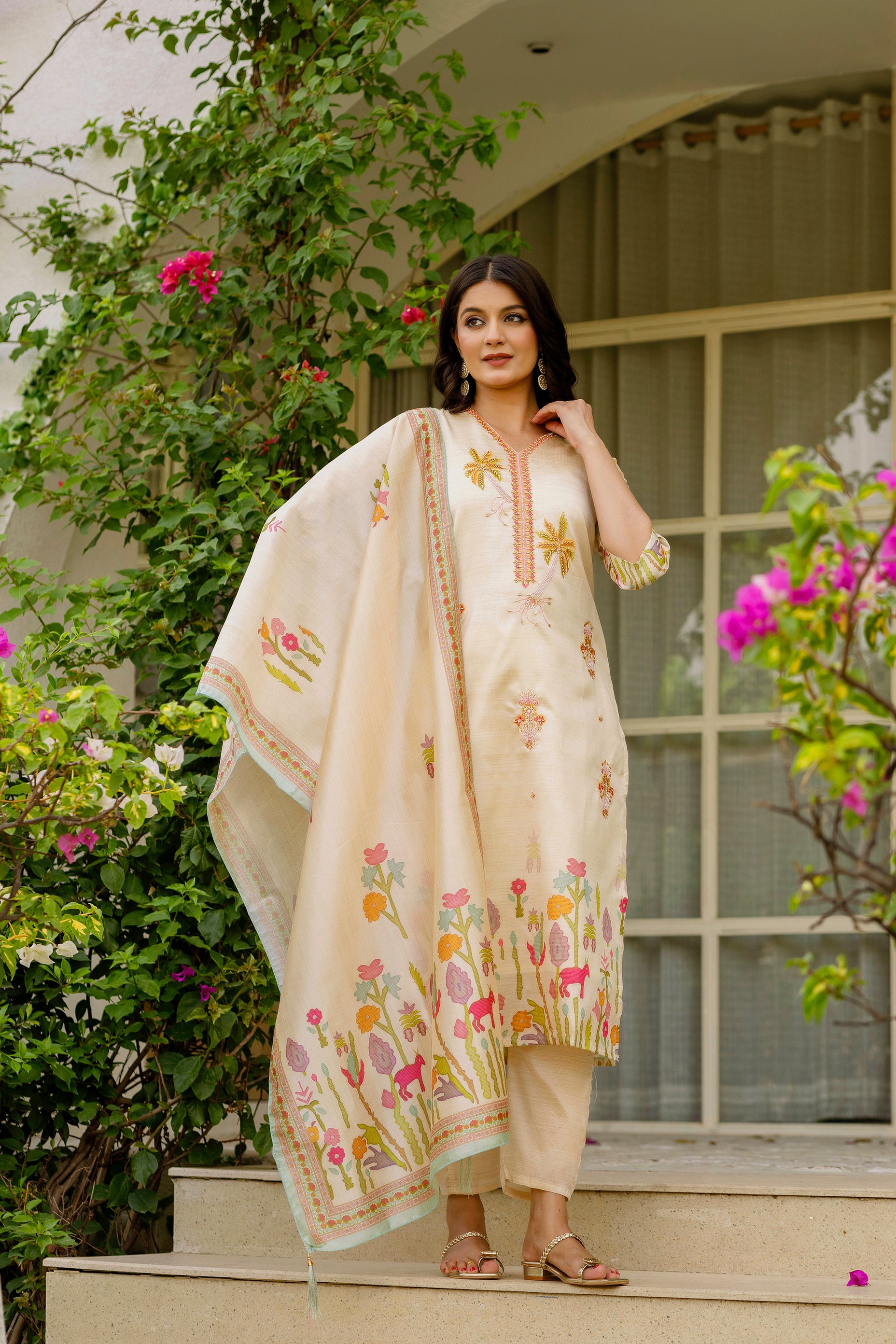 Female model posing elegantly in TRENDBUY cream embroidered kurti set, displaying the flowing dupatta.