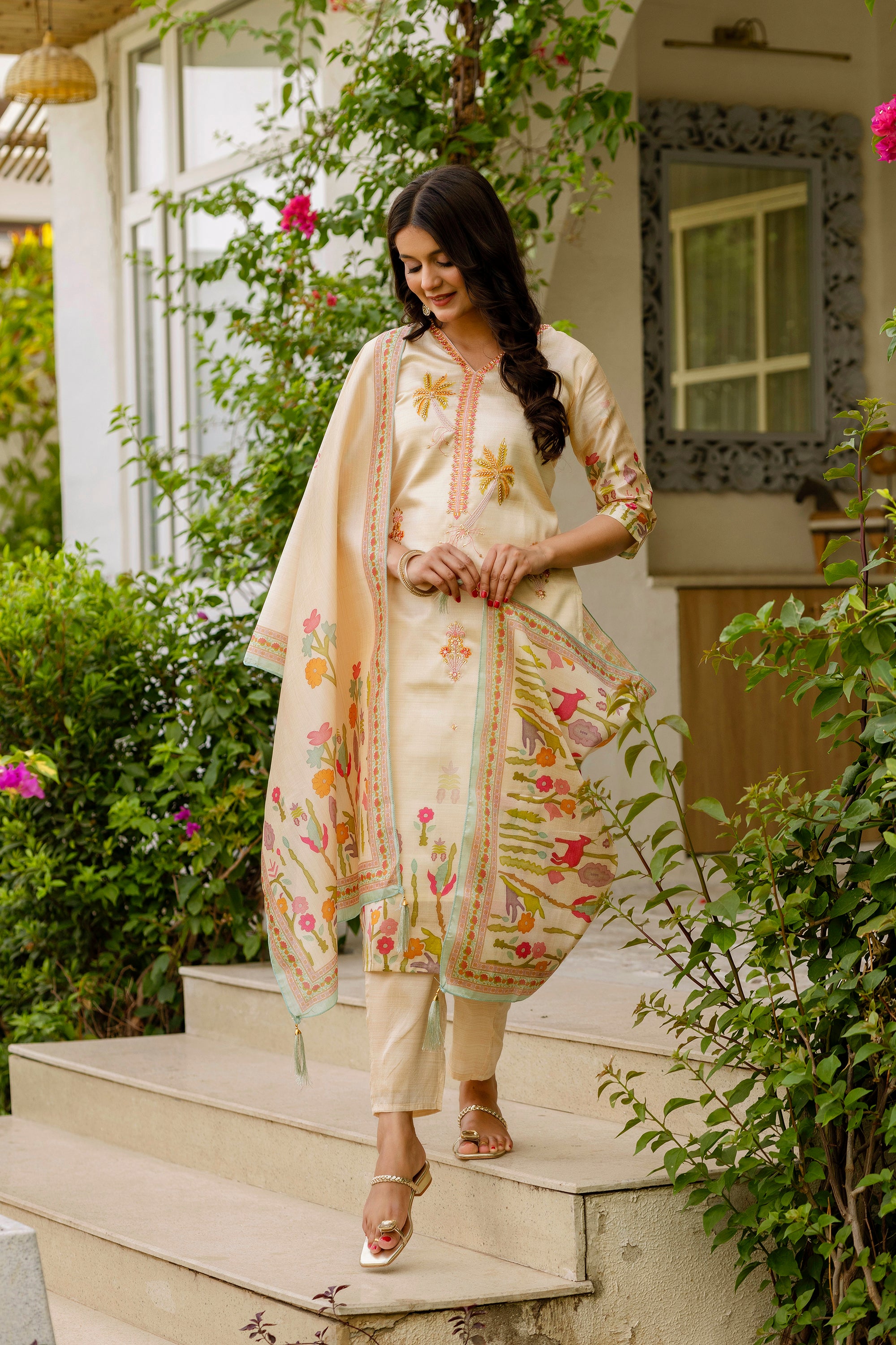 Model walking down steps in the TRENDBUY Viscose Assam Silk Kurta Set, showing the outfit's movement and detailed embroidery.