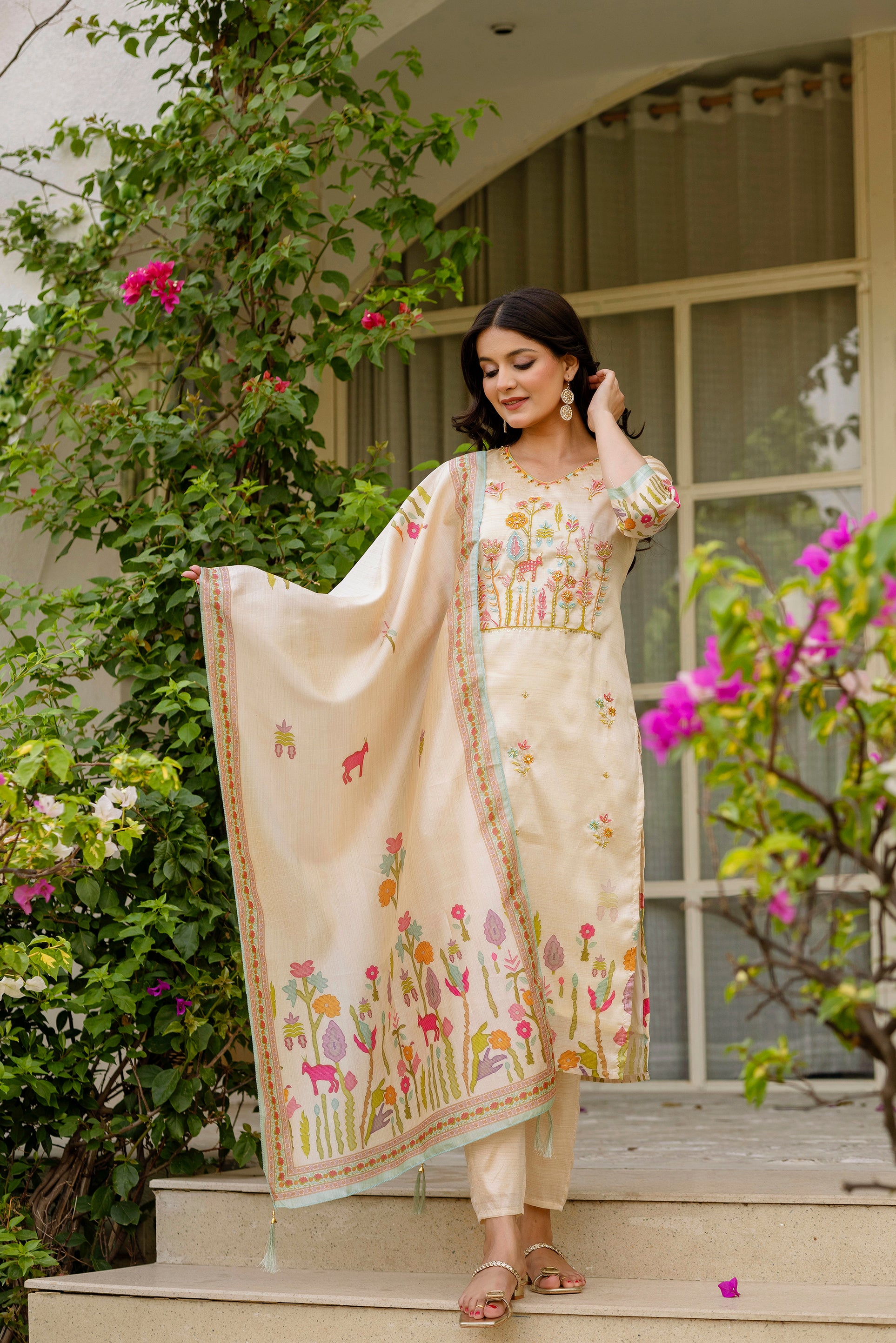 Elegant model showcasing TRENDBUY Viscose Assam Silk Kurta Set with embroidered kurti, matching pant, and floral print dupatta, posing gracefully outdoors.
