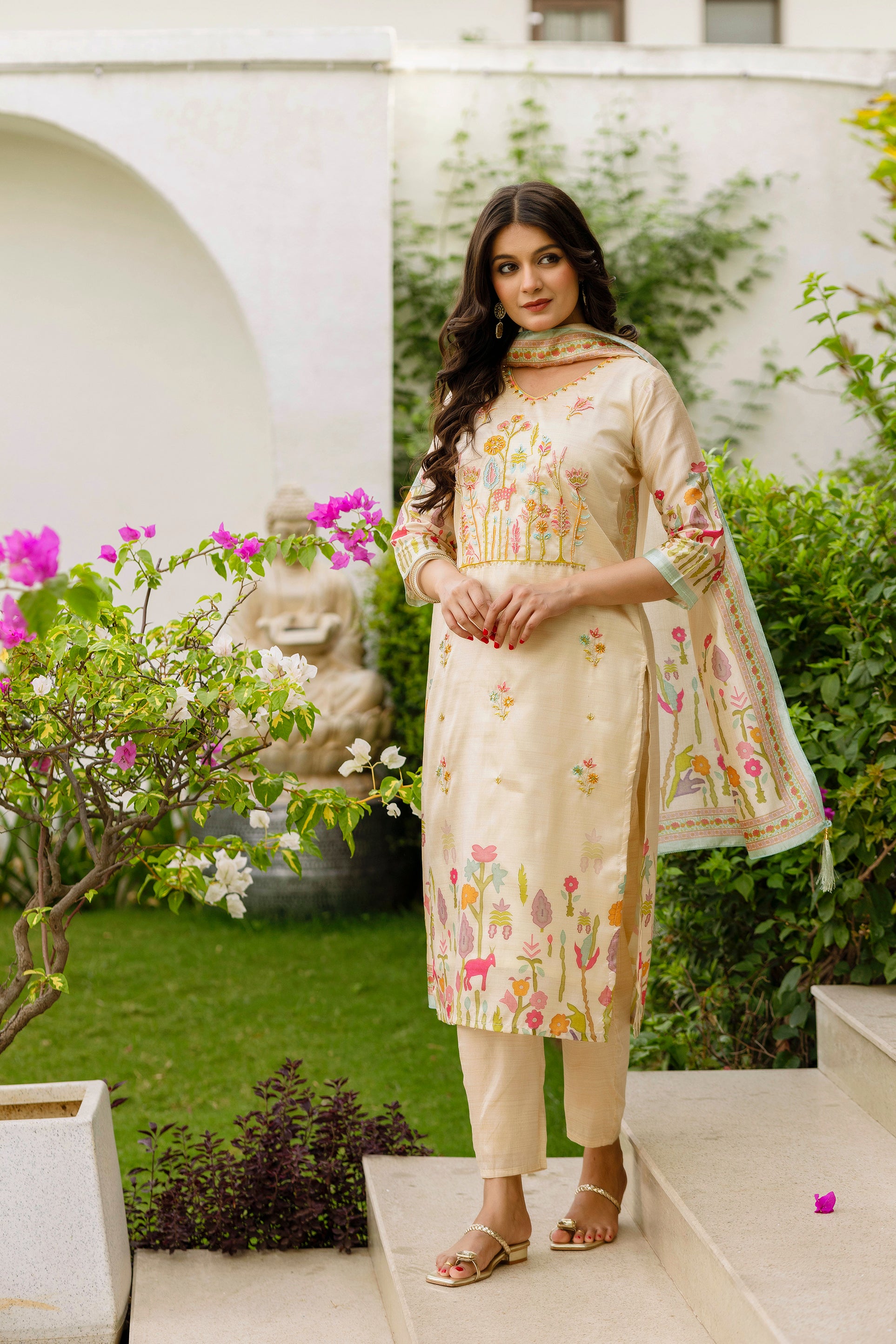 Full-length shot of a confident model wearing the TRENDBUY HR-26 Viscose Assam Silk Kurta Set with elaborate embroidery, standing in a garden setting.