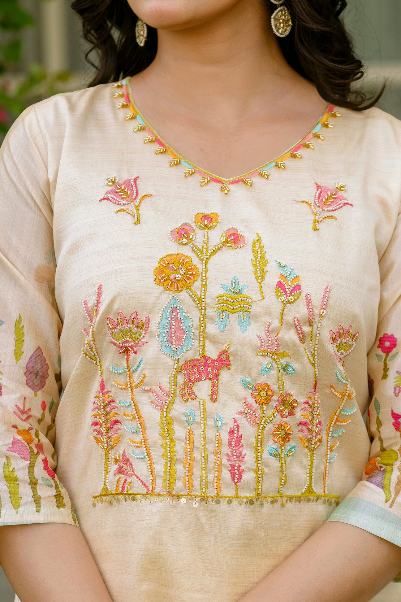 Detailed view of the embroidered beadwork and colorful floral motifs on the front panel of the TRENDBUY Viscose Assam Silk Kurta.