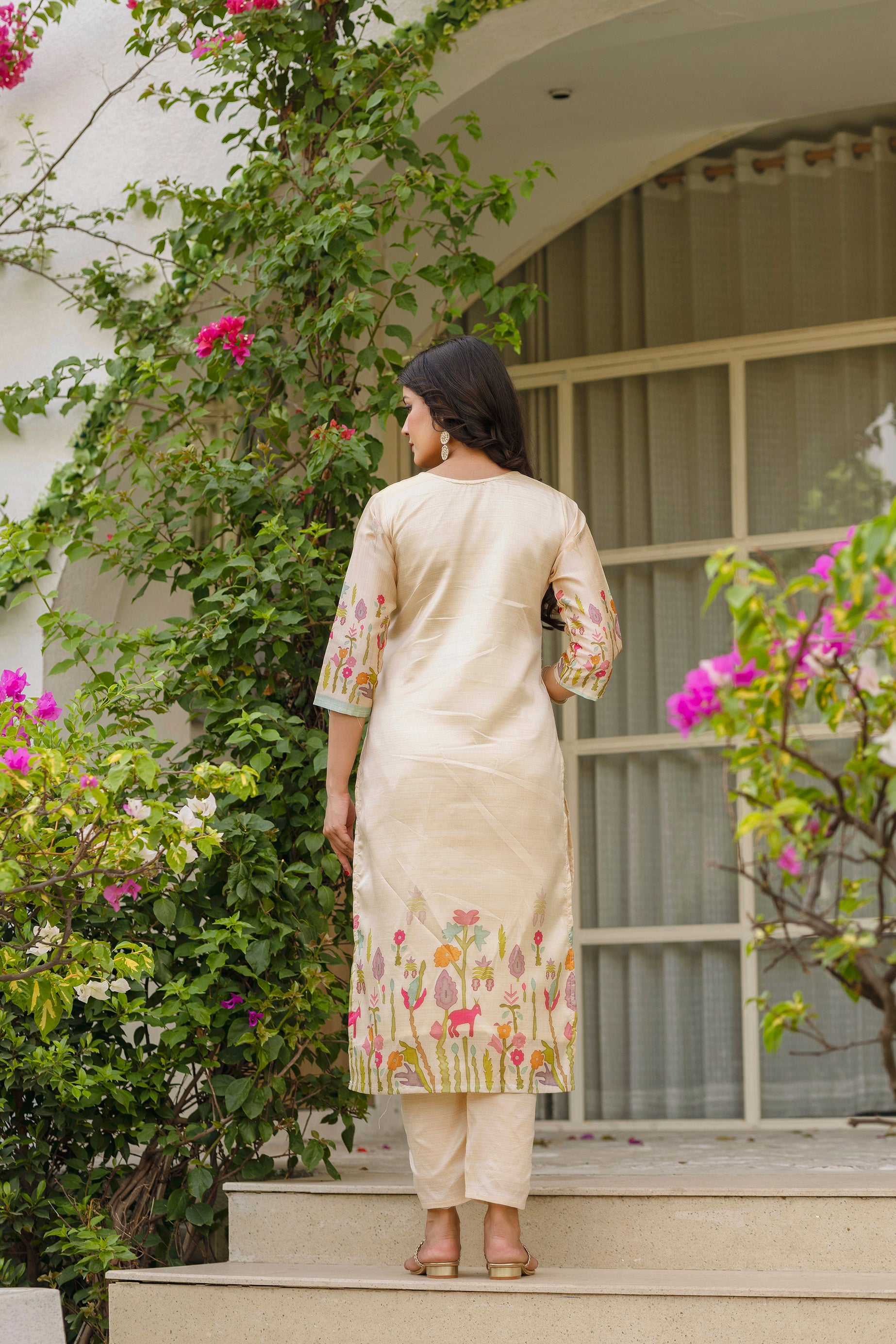 Rear view of model in TRENDBUY Viscose Assam Silk Kurta Set, showcasing the consistent embroidery pattern on the lower back of the kurti and the pant fit.