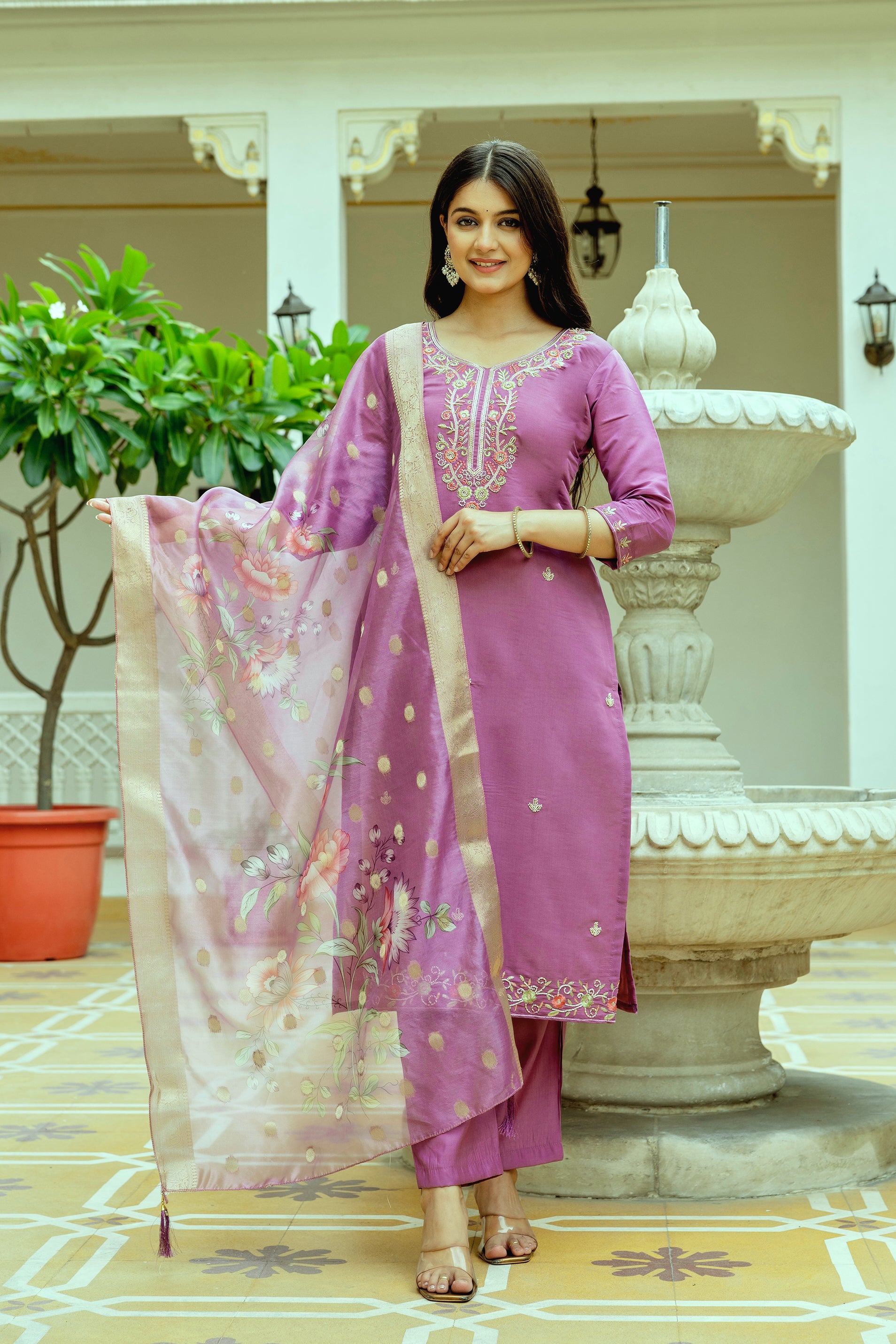 Smiling woman posing gracefully in a vibrant violet Viscose Chanderi silk embroidered kurti set with a floral tabby organza dupatta by TRENDBUY