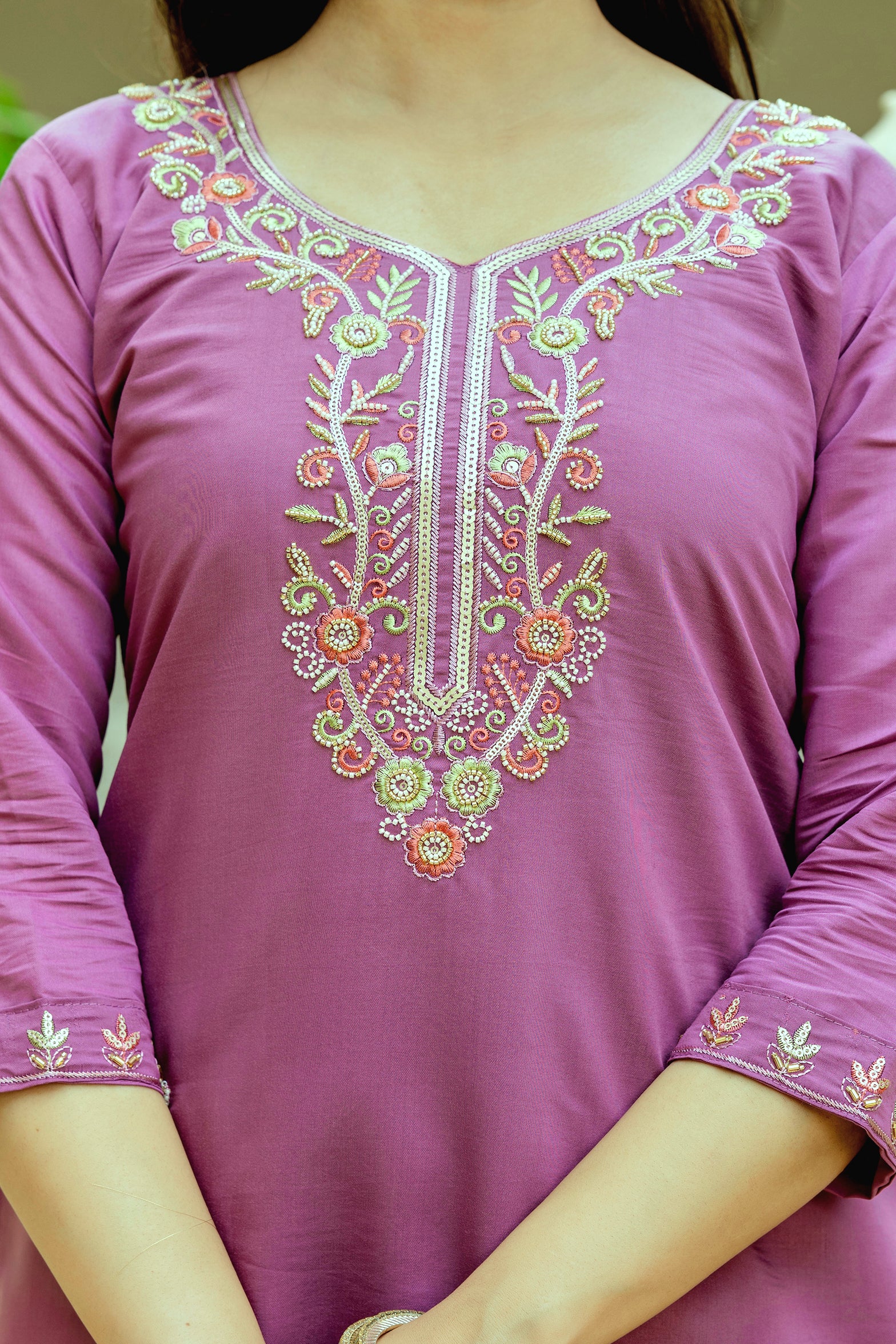Front view of the violet Viscose Chanderi silk kurti with delicate embroidery, showcasing the full ensemble worn by the model with hands clasped