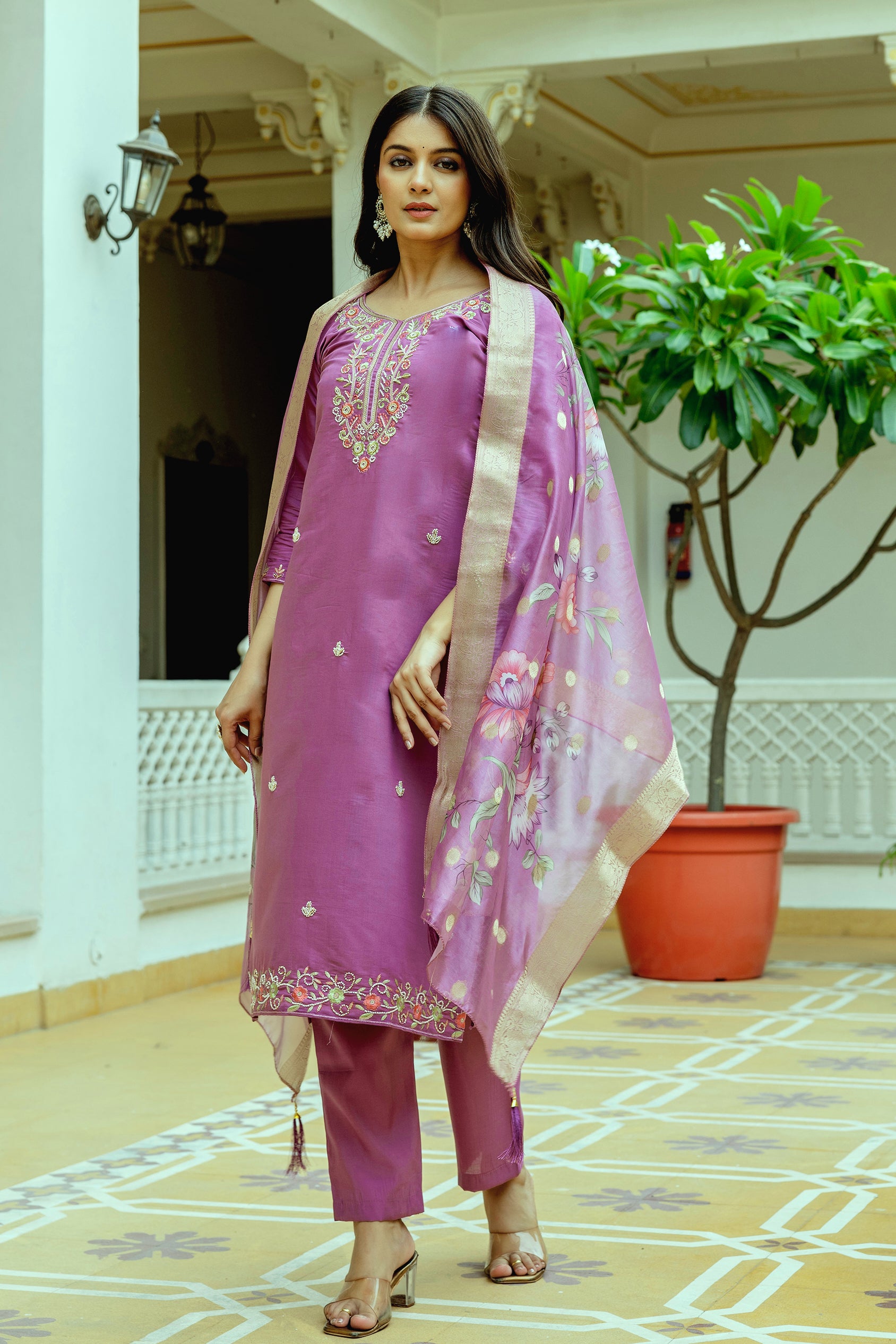 Confident woman in the full TRENDBUY violet embroidered kurti set, displaying the elegant side profile and the tasteful embroidery on the kurti hem
