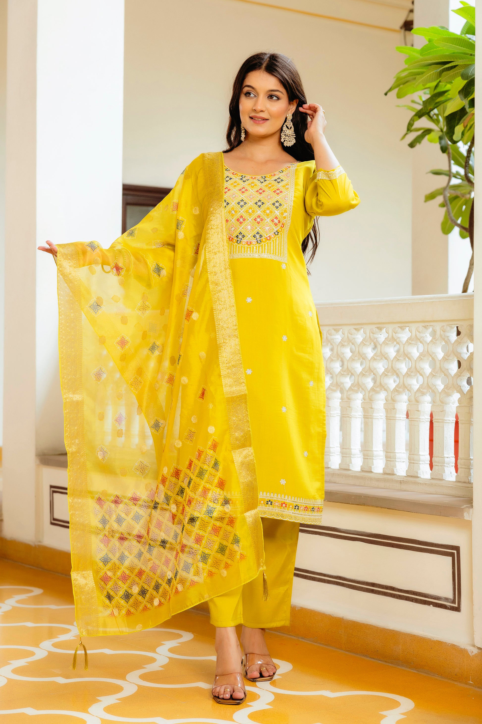 Model gracefully posing in the yellow embroidered kurta set, showing the flow and intricate patterns of the Jacquard Tabby Organza dupatta.