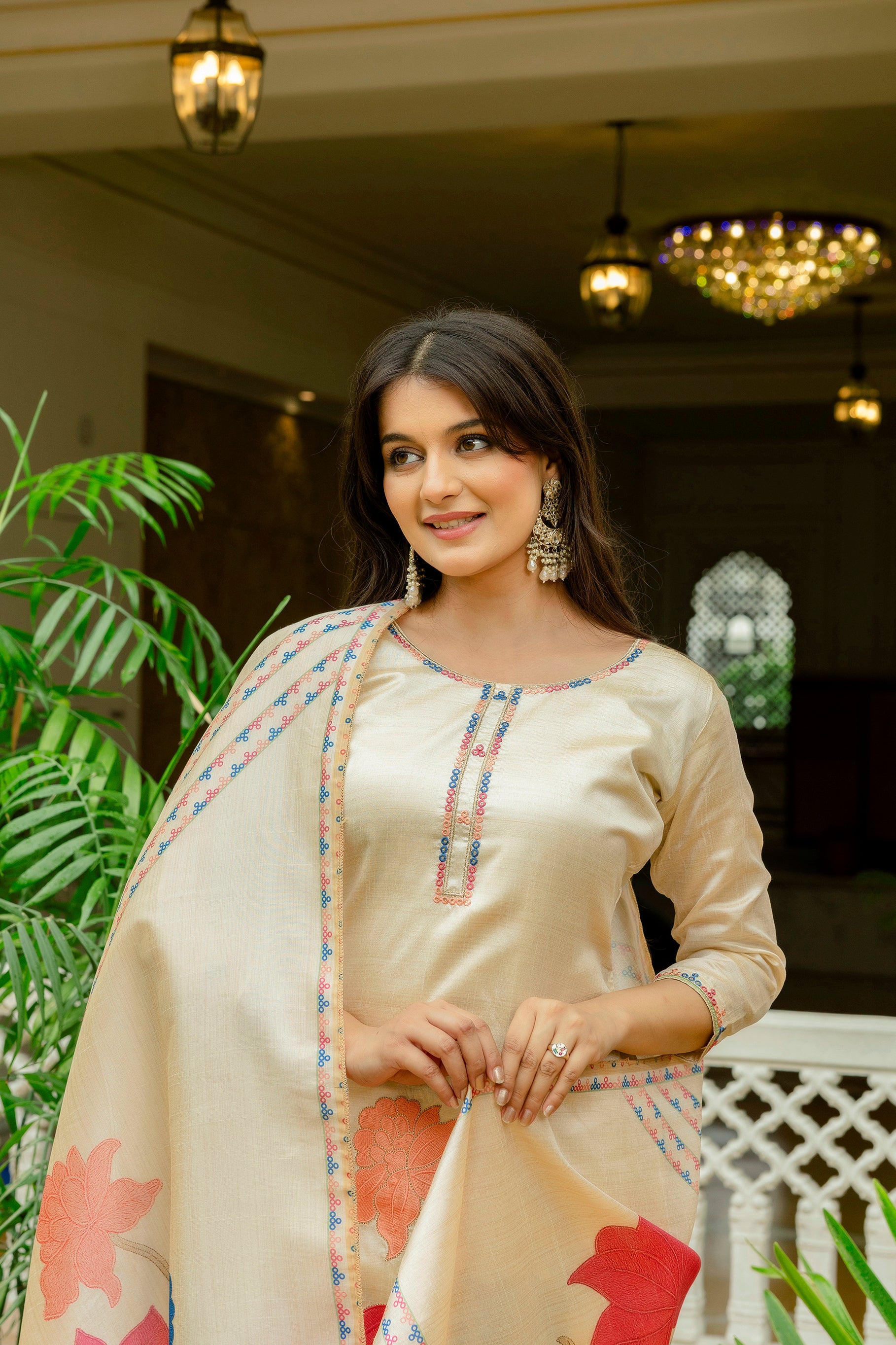 Close-up of the model, focusing on the intricate embroidered neckline and sleeve details of the beige Viscose Assam Silk kurta.