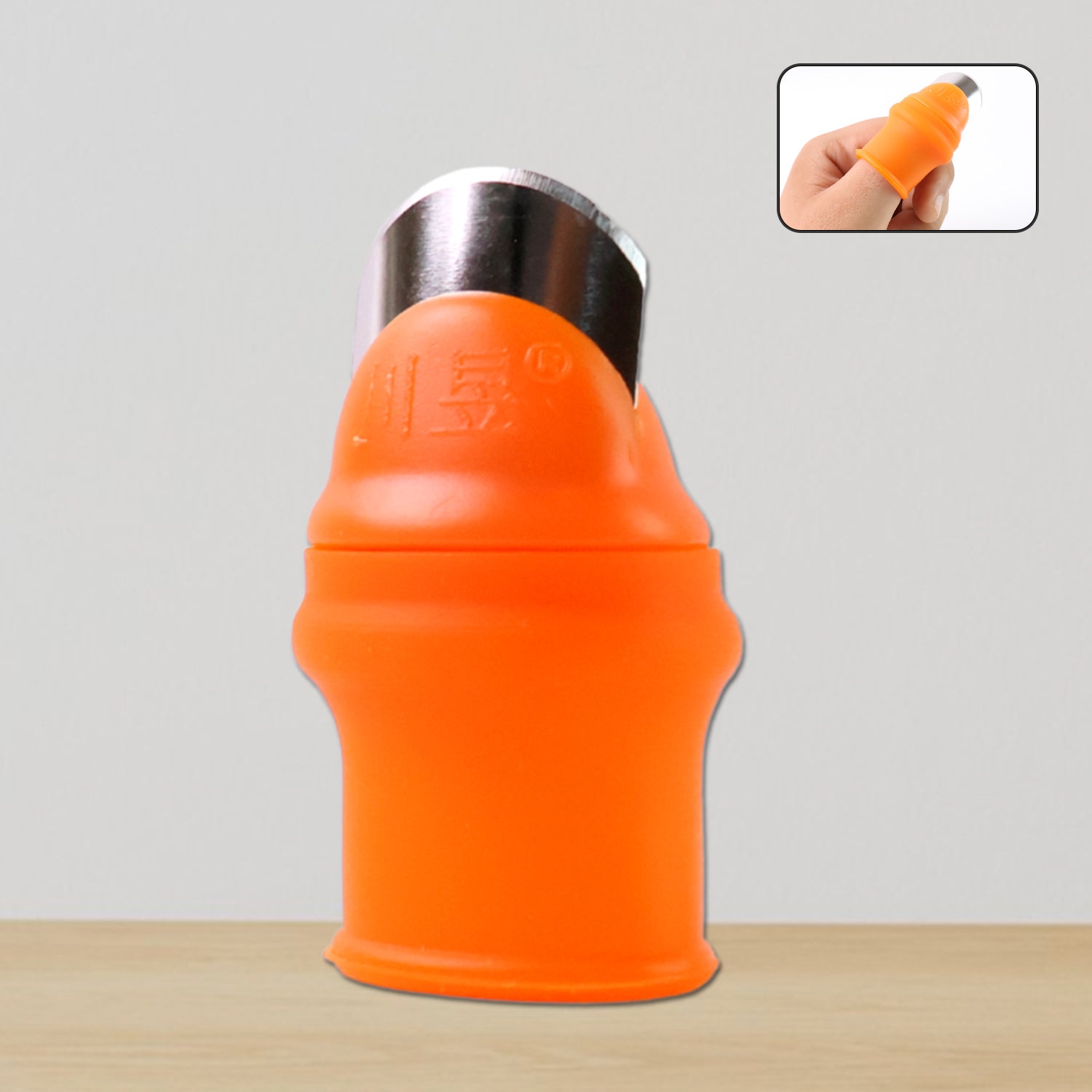 Thumb knife cutter with silicone guard actively harvesting a small green vegetable pod.