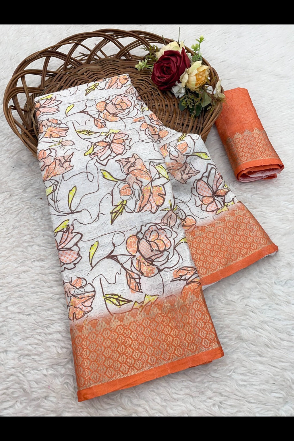 Close-up of vibrant orange digital prints and Banarasi motifs on white silk fabric