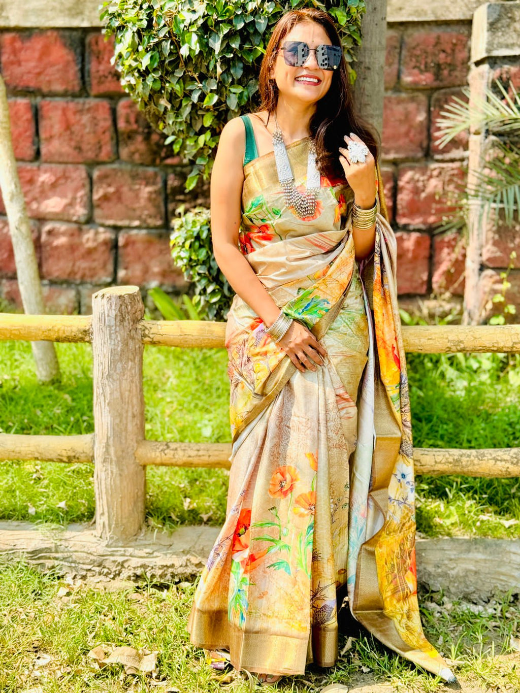 Model wearing elegant golden Dola silk saree with intricate border and rich drape