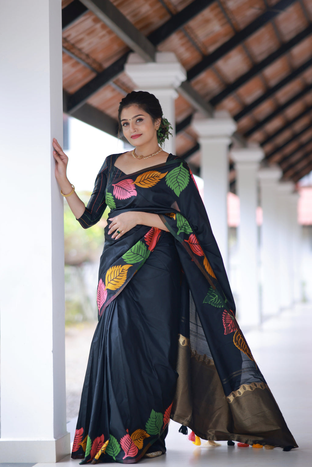 Close-up of intricate multicolor leaf motifs woven on black silk fabric