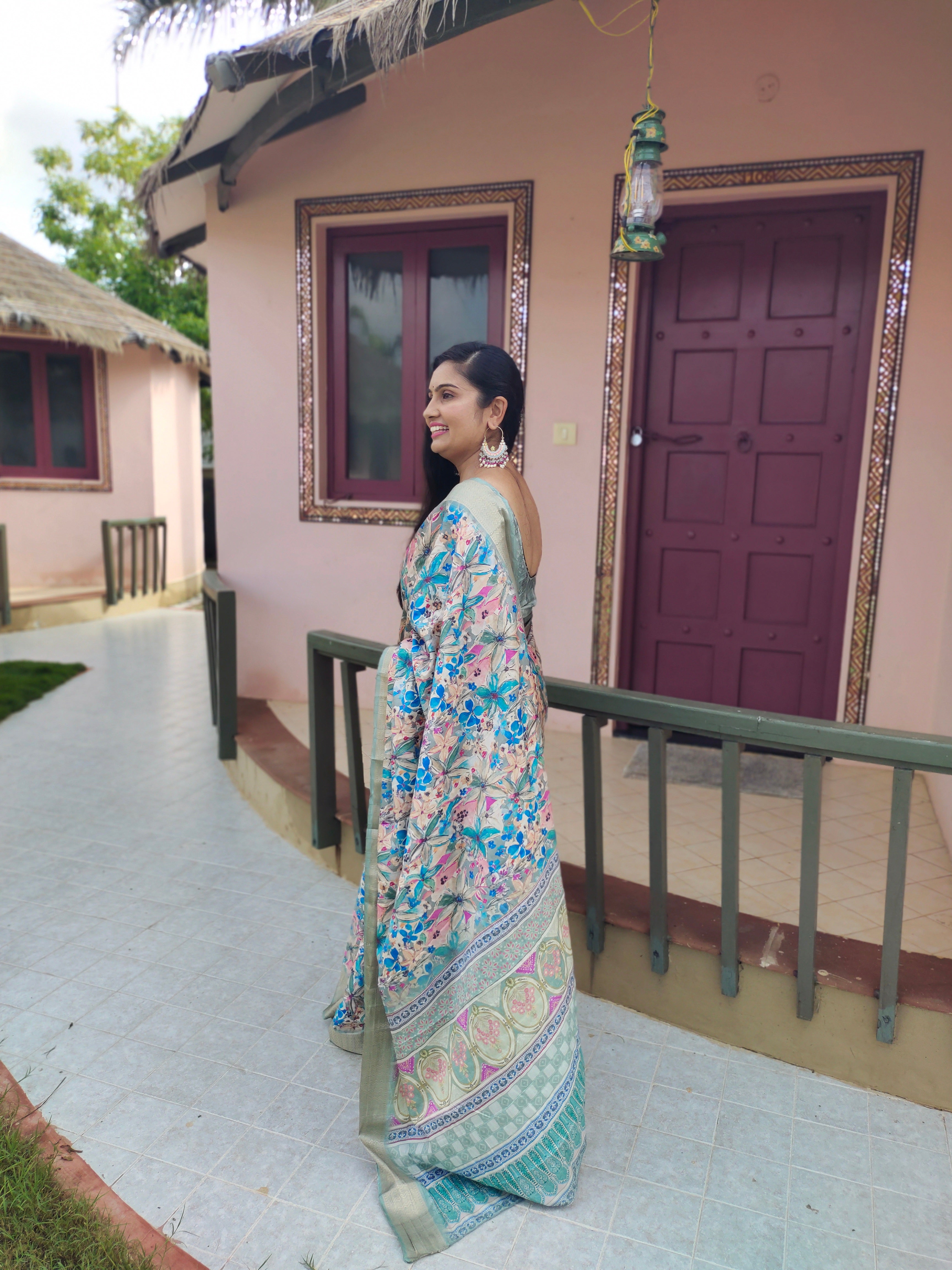 Woman wearing a latest designer digital printed saree with a matching blouse.