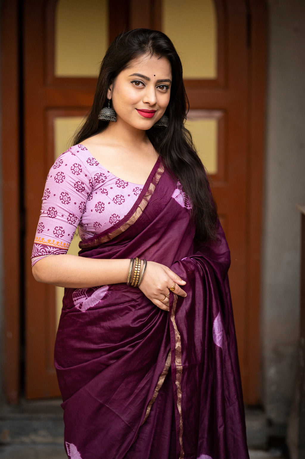 Close-up of the intricate hand-block printed pallu with delicate cotton tassels