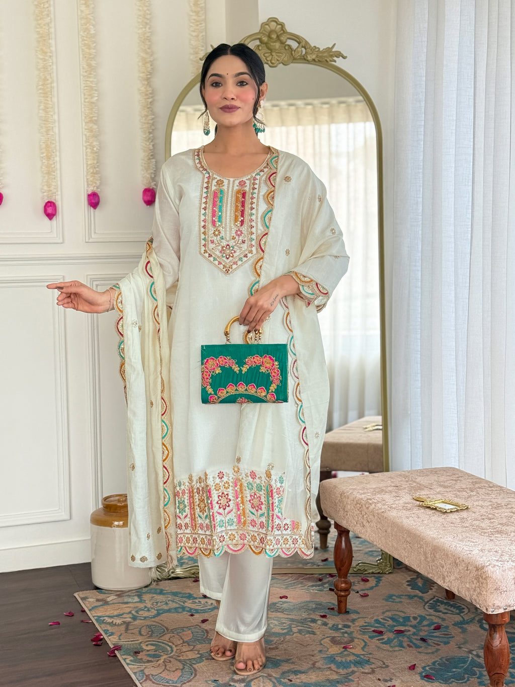 Elegant model showcasing TRENDBUY's VI-ANAMIKA Viscose Chanderi embroidered kurta set with pant and dupatta, holding a green clutch.