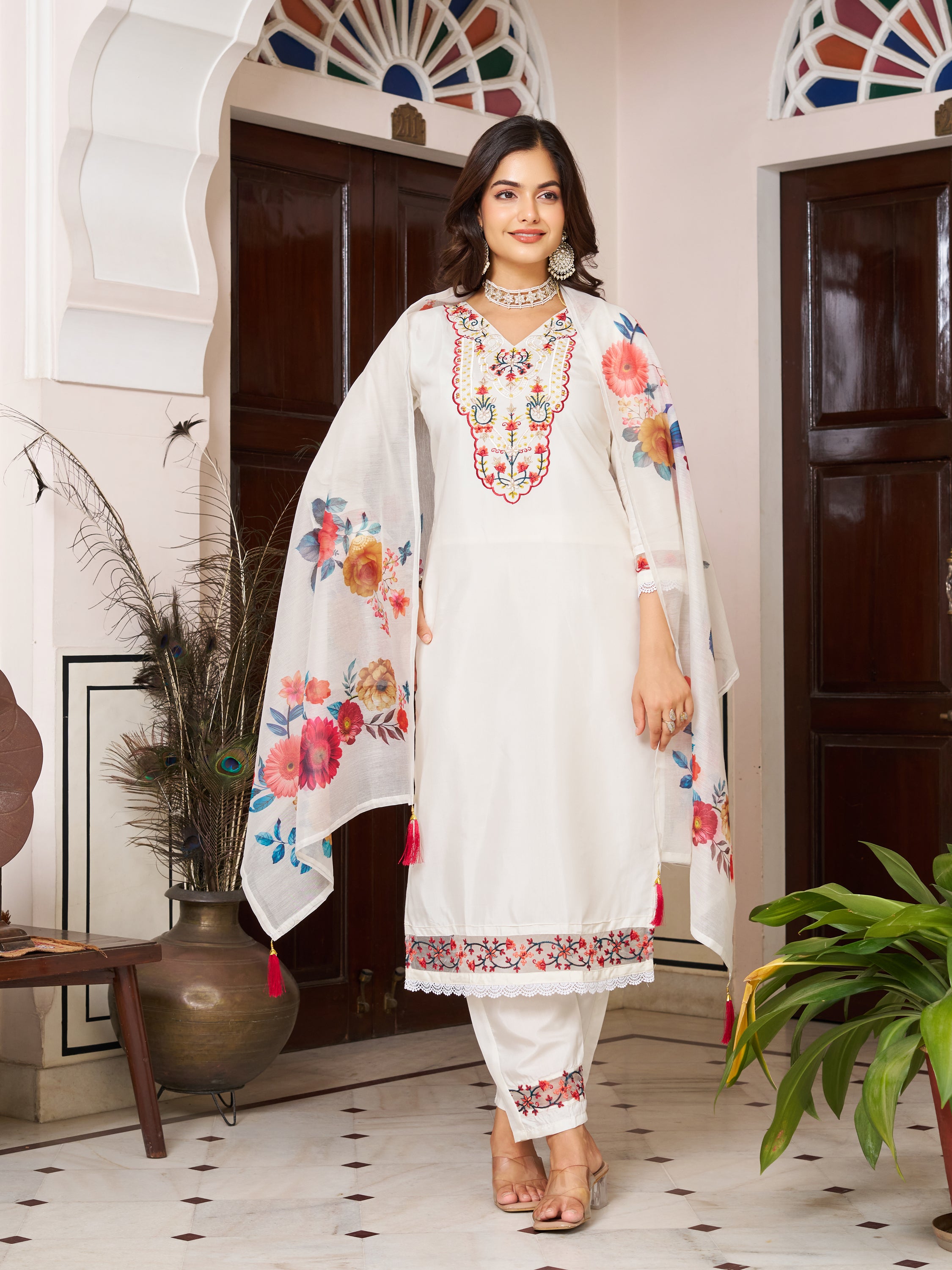 Front view of a woman in a white Chanderi silk kurta set, showcasing the embroidered neckline and floral dupatta.