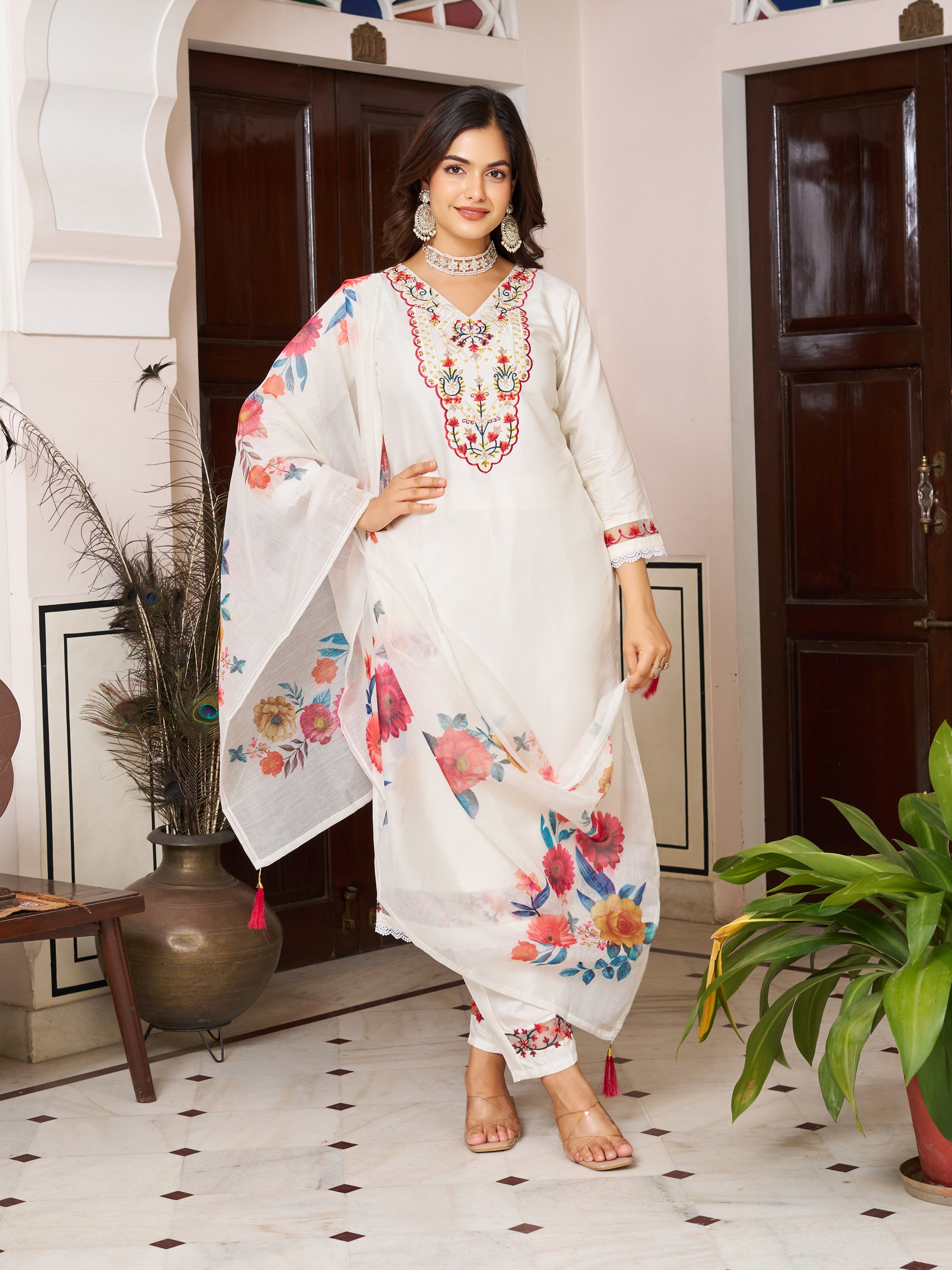 Woman in a white Chanderi silk kurta set, gracefully holding the floral printed dupatta.