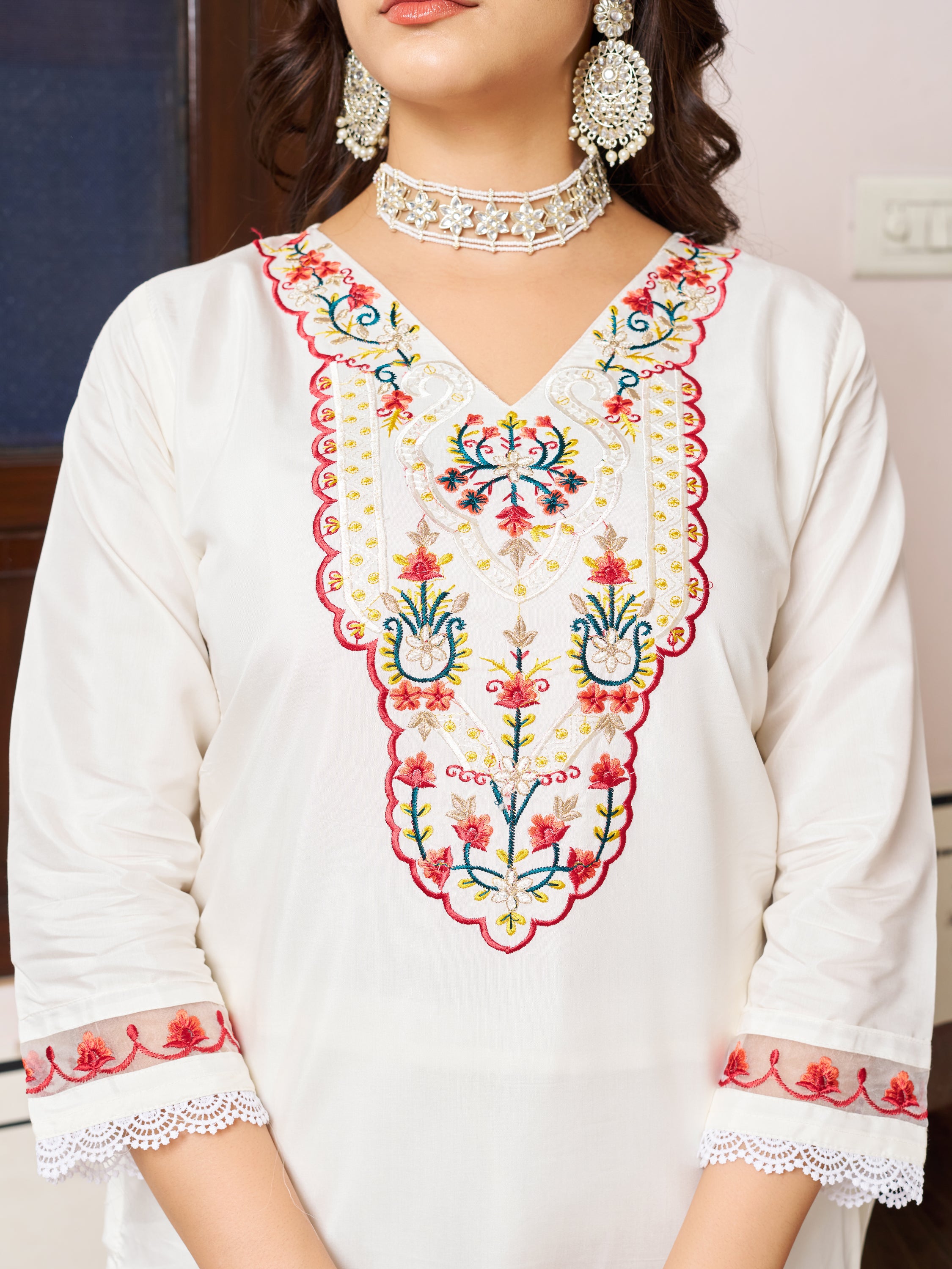 Close-up of the intricate embroidery on the neckline and sleeves of the white Chanderi silk kurta.