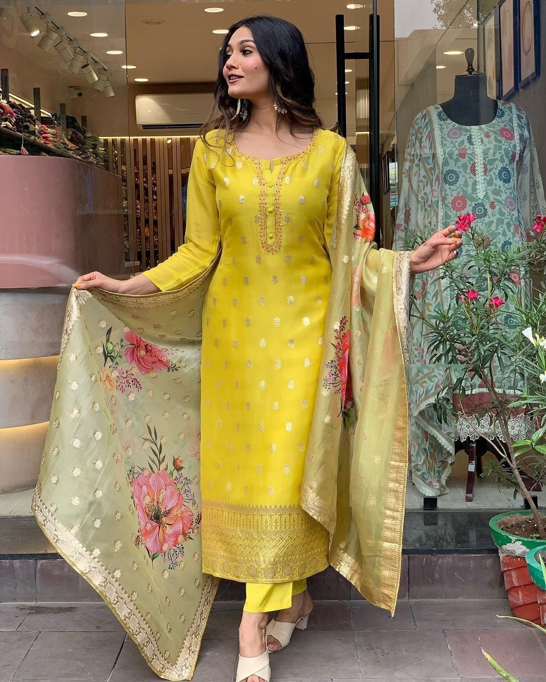 Stylish woman showcasing the full flow and graceful drape of the yellow kurti, pant, and dupatta set.