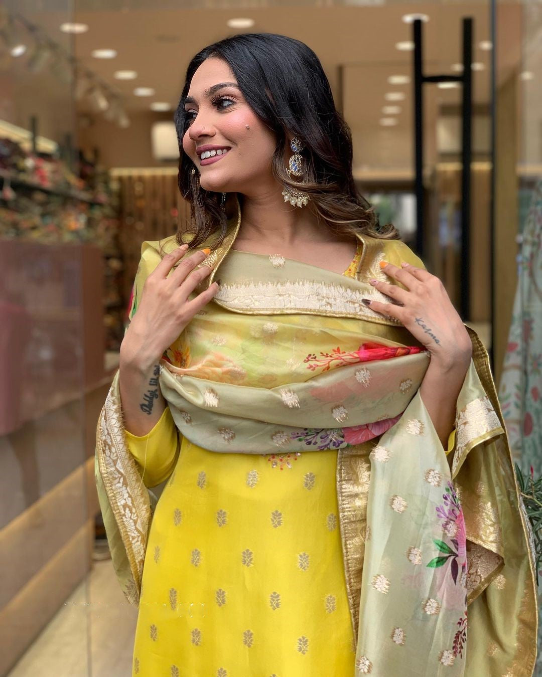 Woman smiling, showing the delicate gold thread embroidery on the kurti and the soft texture of the jacquard dupatta.