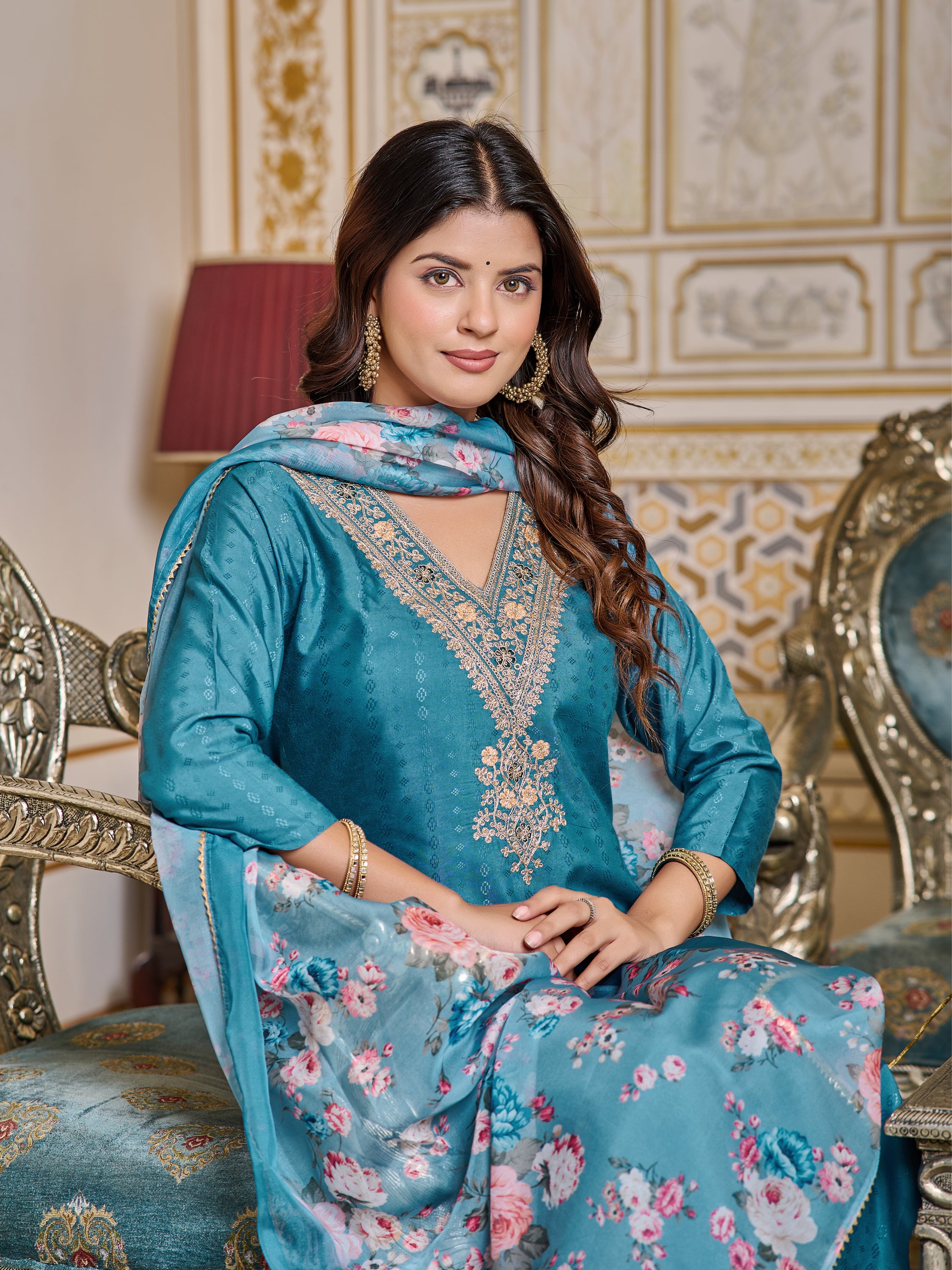 Close-up portrait of the model sitting, emphasizing the elegant embroidery and the pattern of the digital print dupatta.