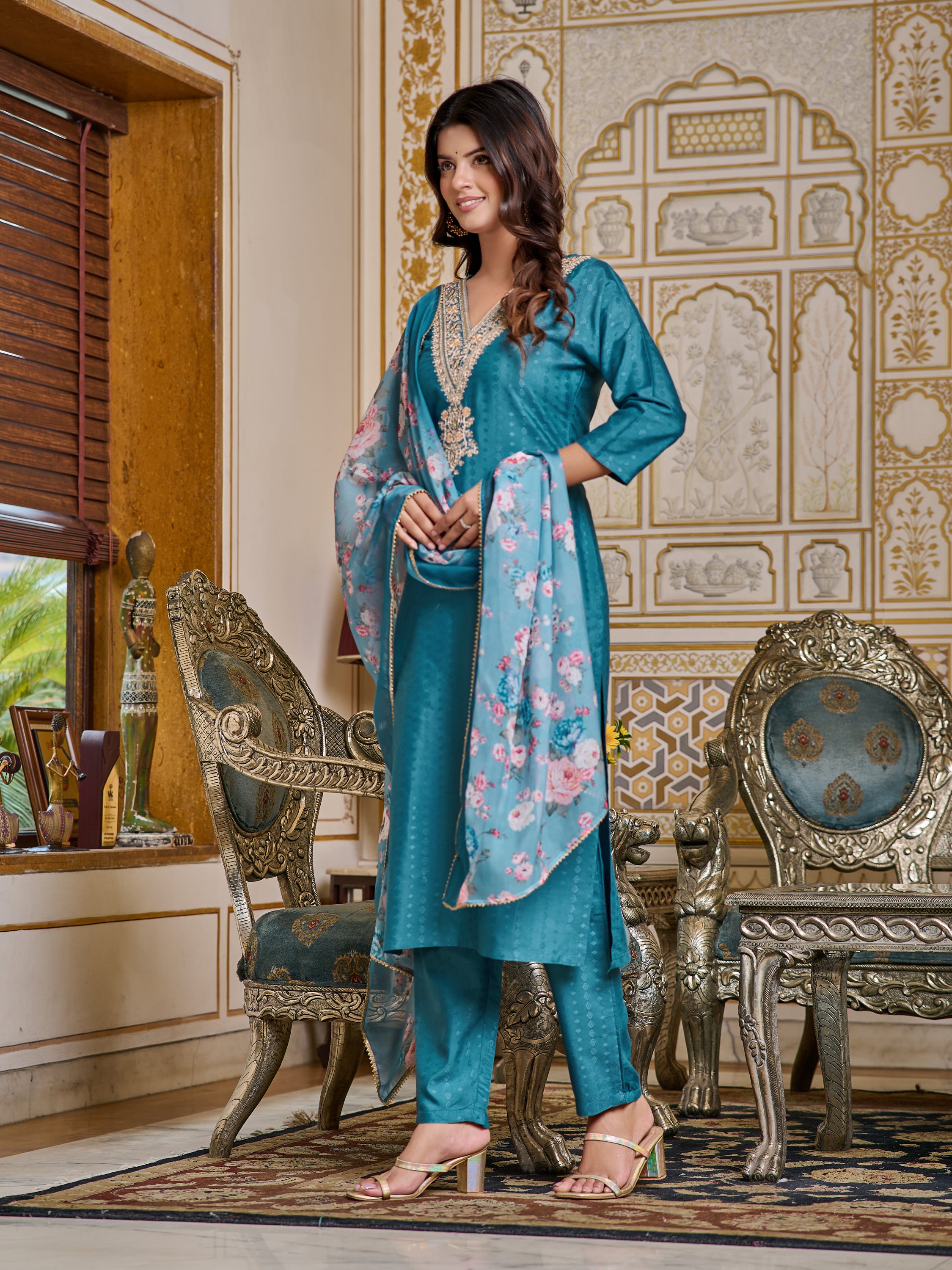 Model showcasing the side profile and drape of the TRENDBUY teal embroidered kurta set, smiling.