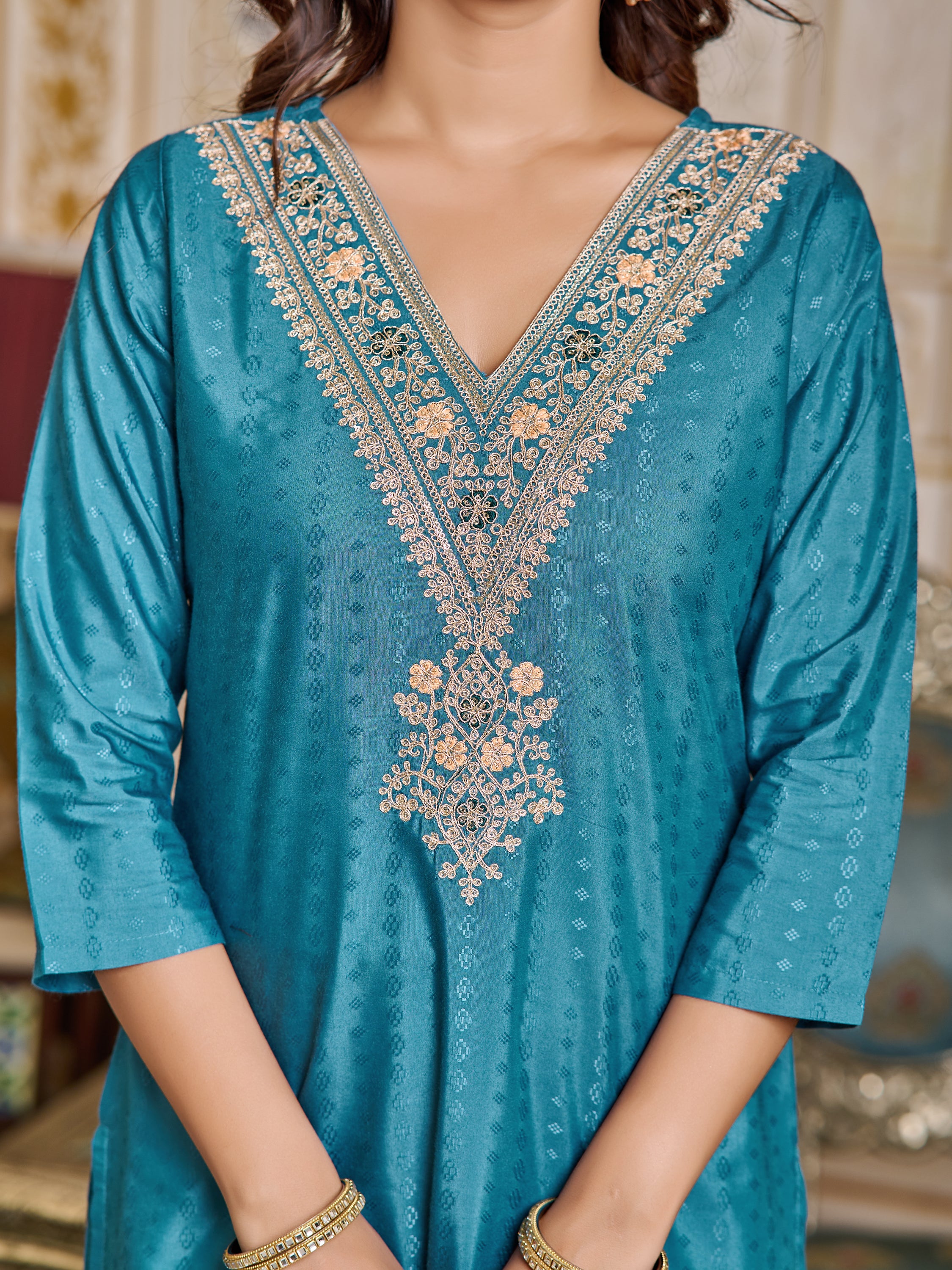 Close-up shot of the intricate heavy embroidery detail on the V-neckline of the TRENDBUY teal viscose rayon kurta.