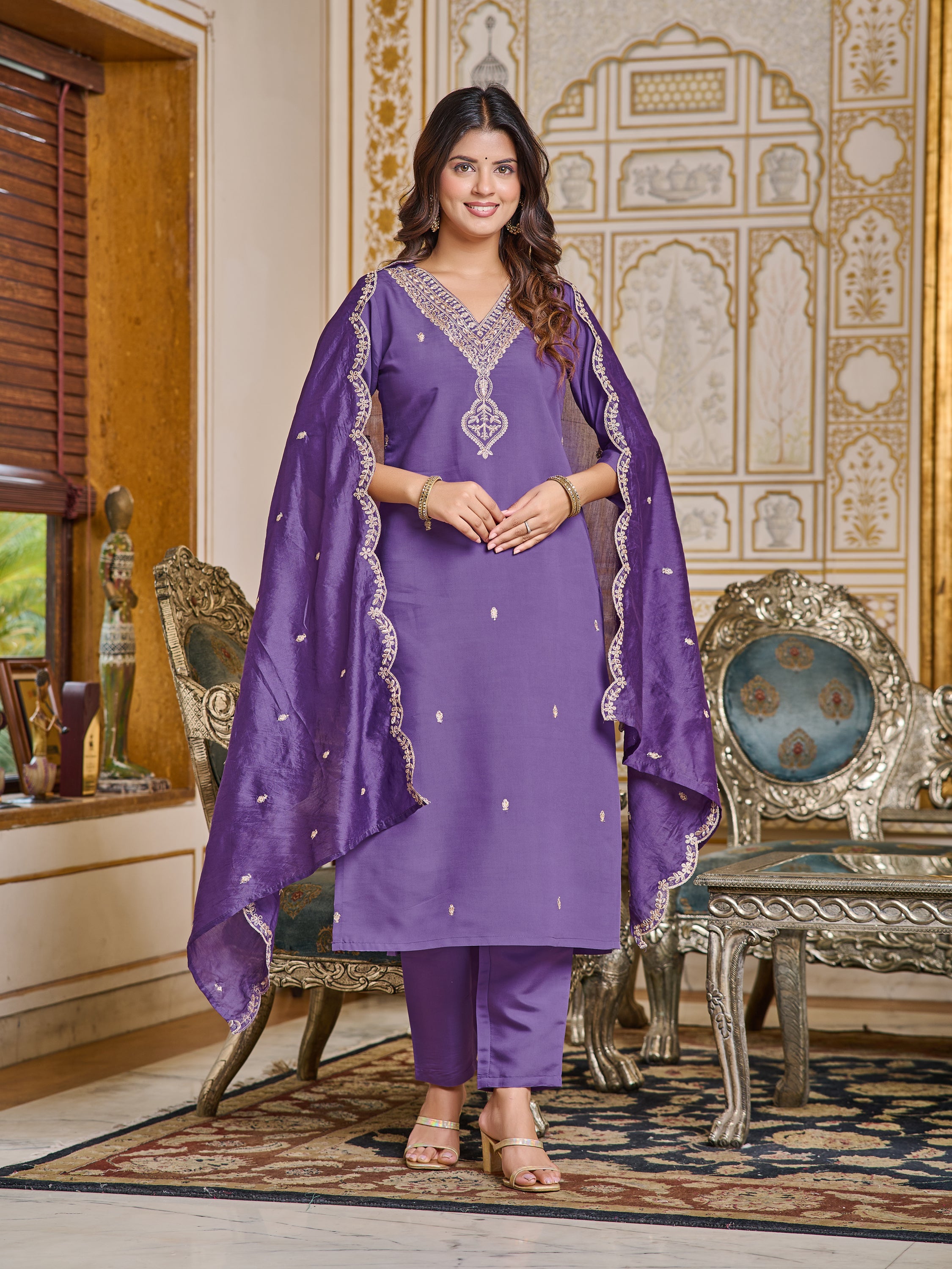 Woman posing confidently with the purple embroidered dupatta draped elegantly over both shoulders.