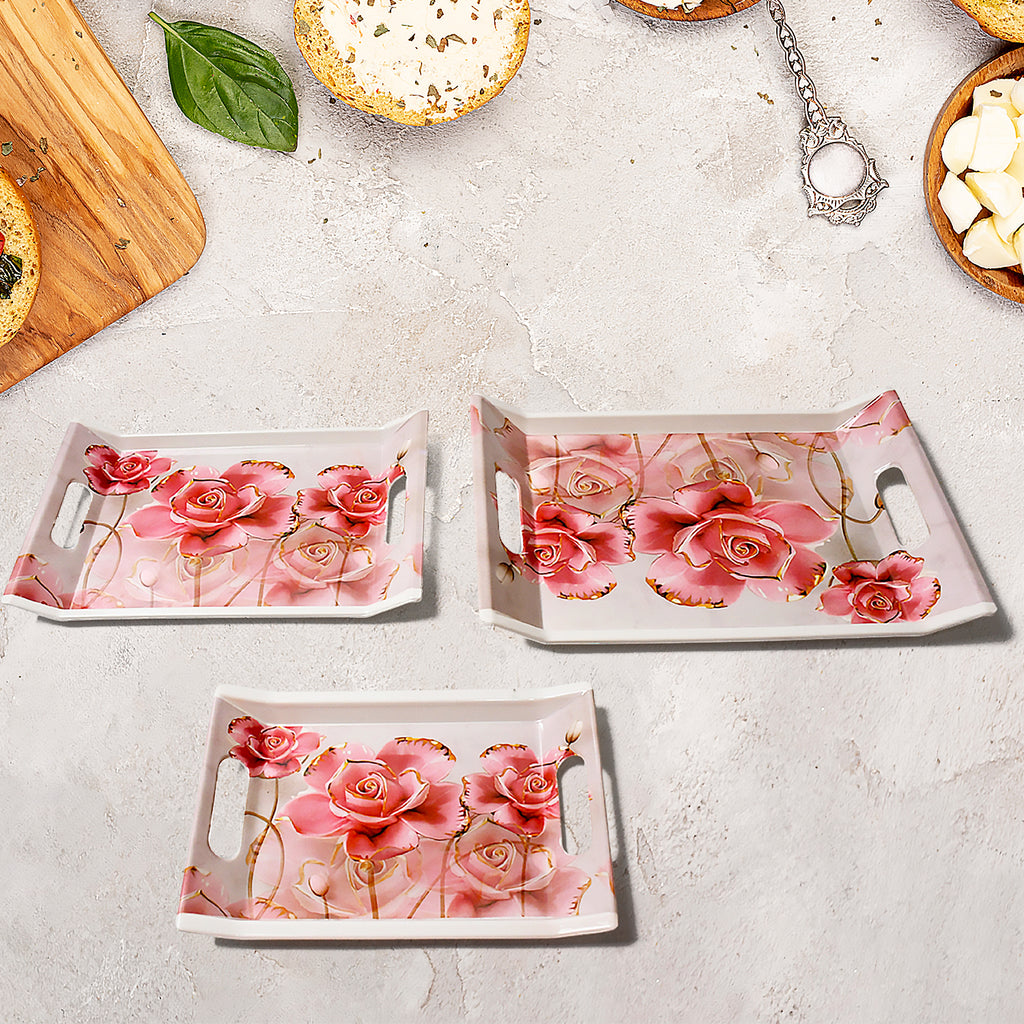Set of 3 plastic rectangular serving trays with floral print design for home kitchen use.