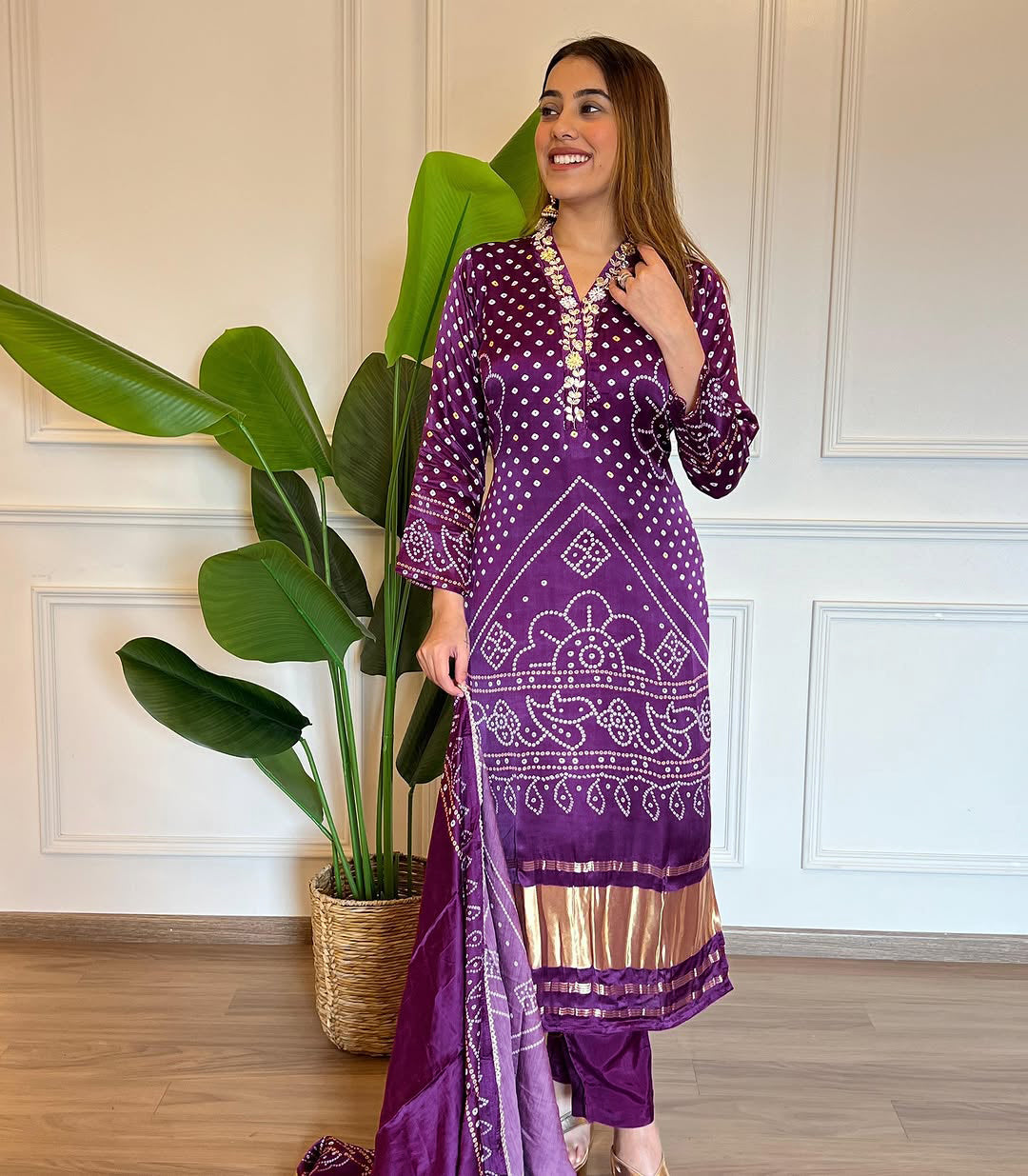 Smiling model wearing the TRENDBUY purple Bandhani kurti set, demonstrating its elegant drape and style.