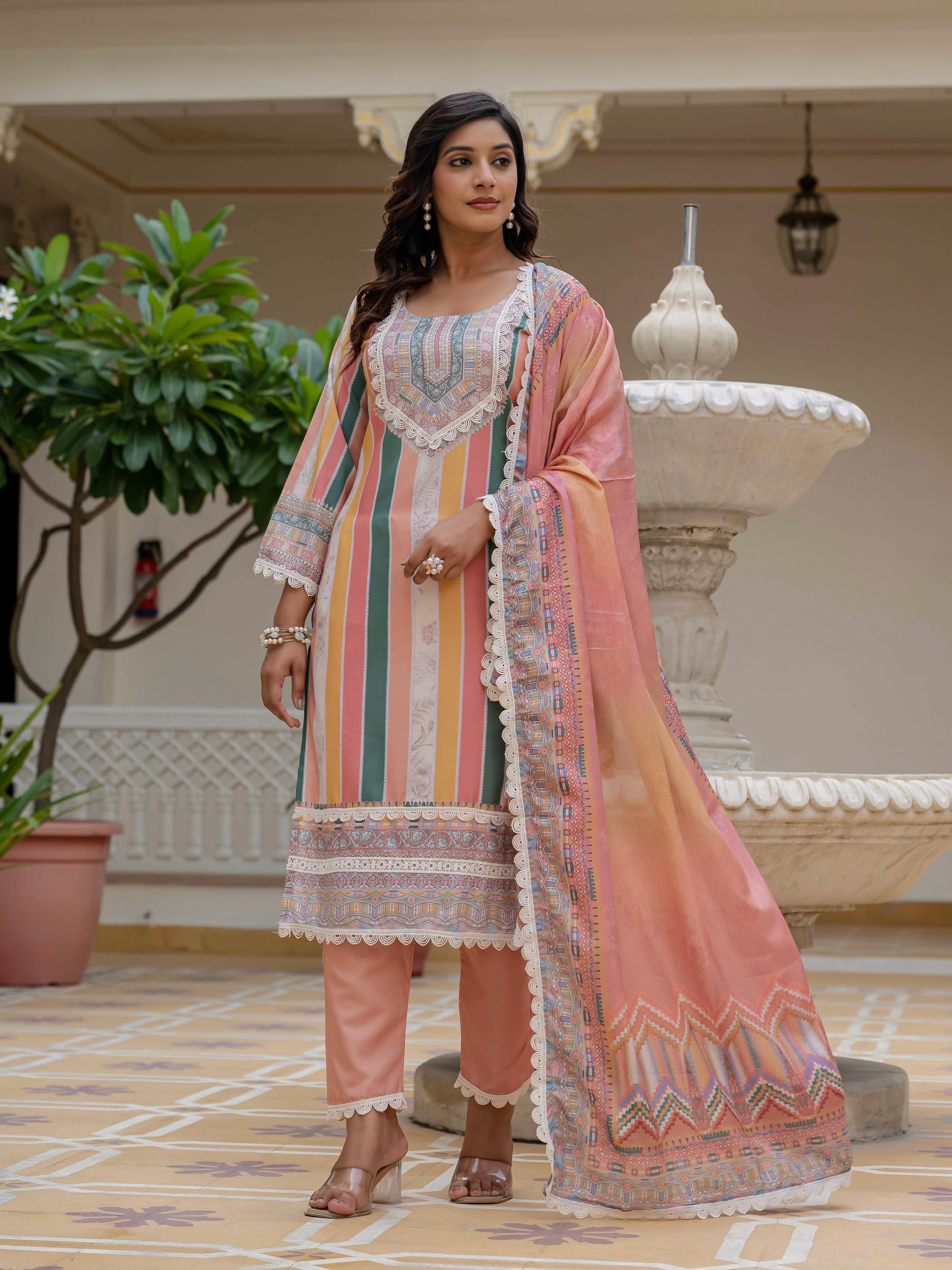 Model in Laila Orange Kurta Set looking to the side, showcasing the outfit's elegant drape and printed dupatta.