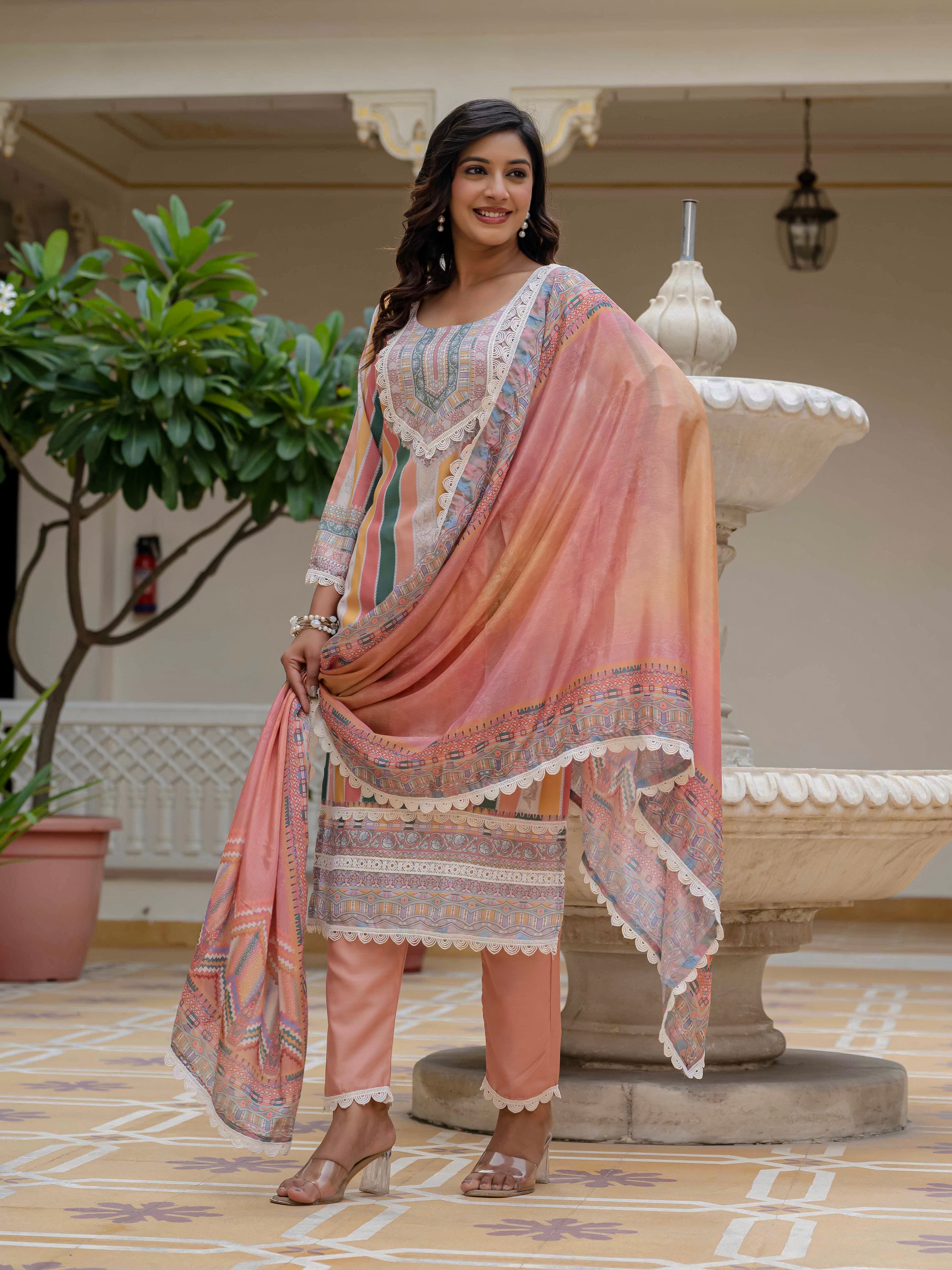 Model smiling in Laila Orange Kurta Set, playfully holding the chinon dupatta for a dynamic pose.