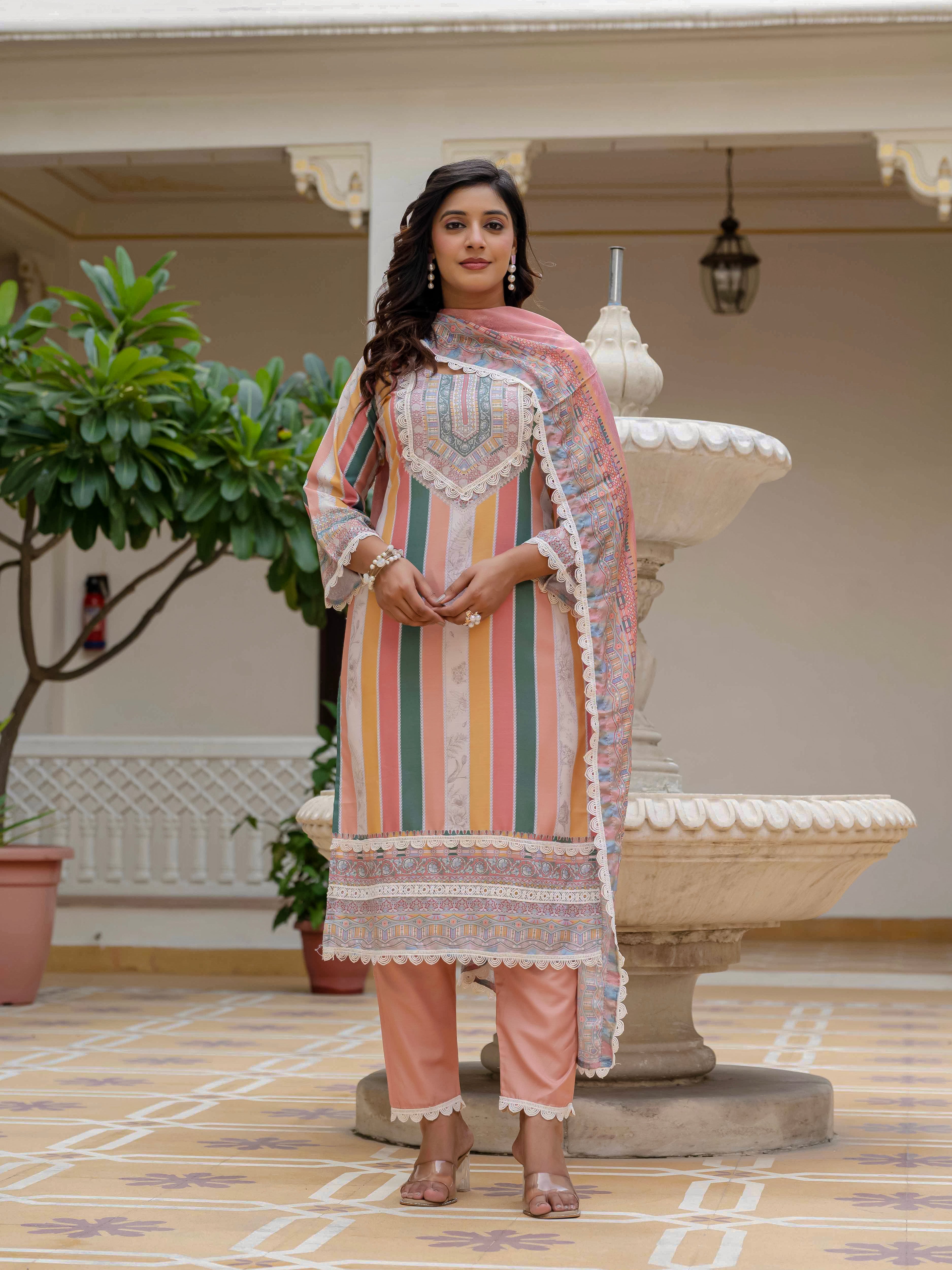 Model in Laila Orange Kurta Set with both hands in front, showing full outfit and accessories details.