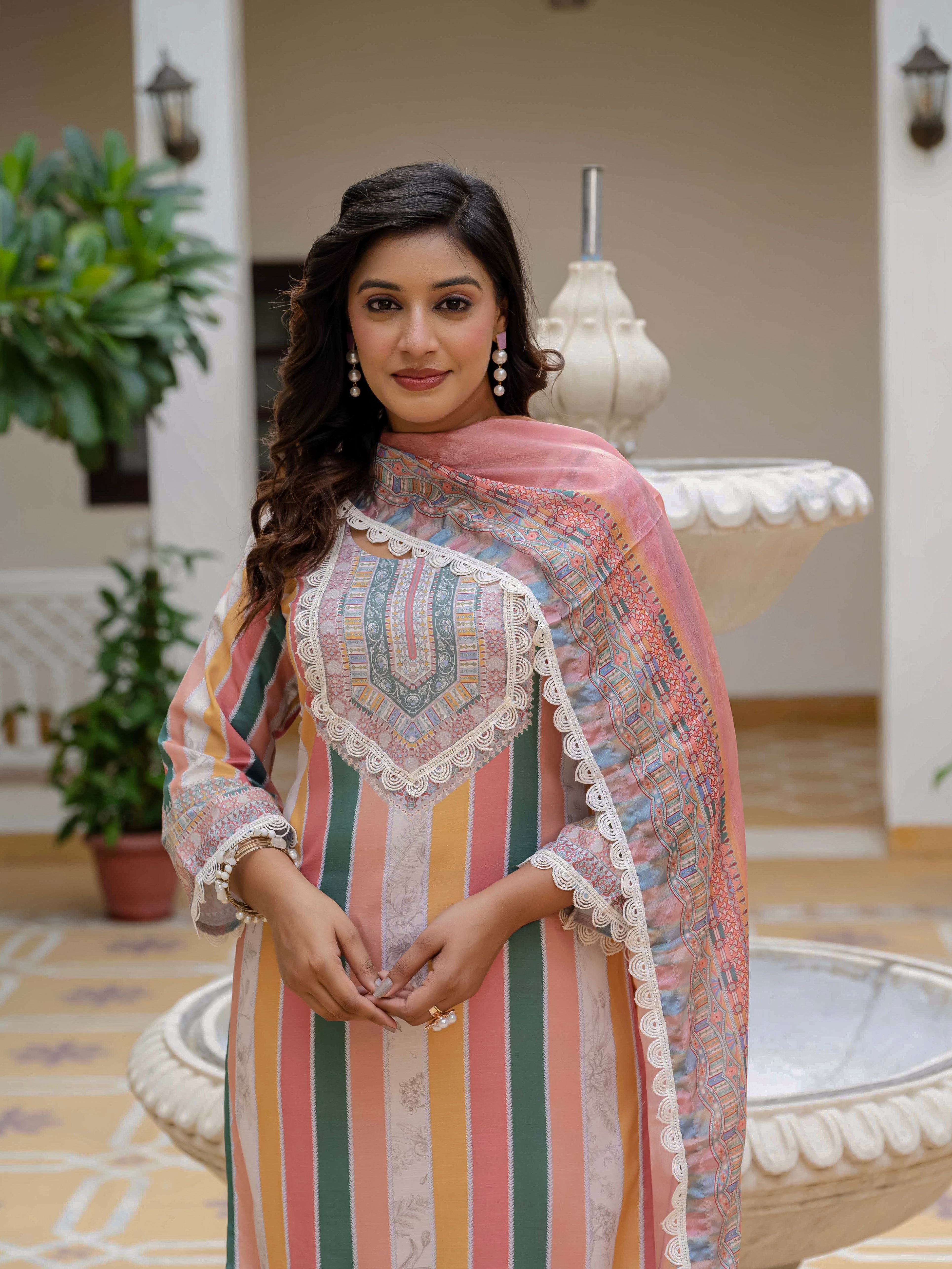 Close-up portrait of the model in Laila Orange Kurta Set, highlighting makeup, hairstyle, and intricate neckline.
