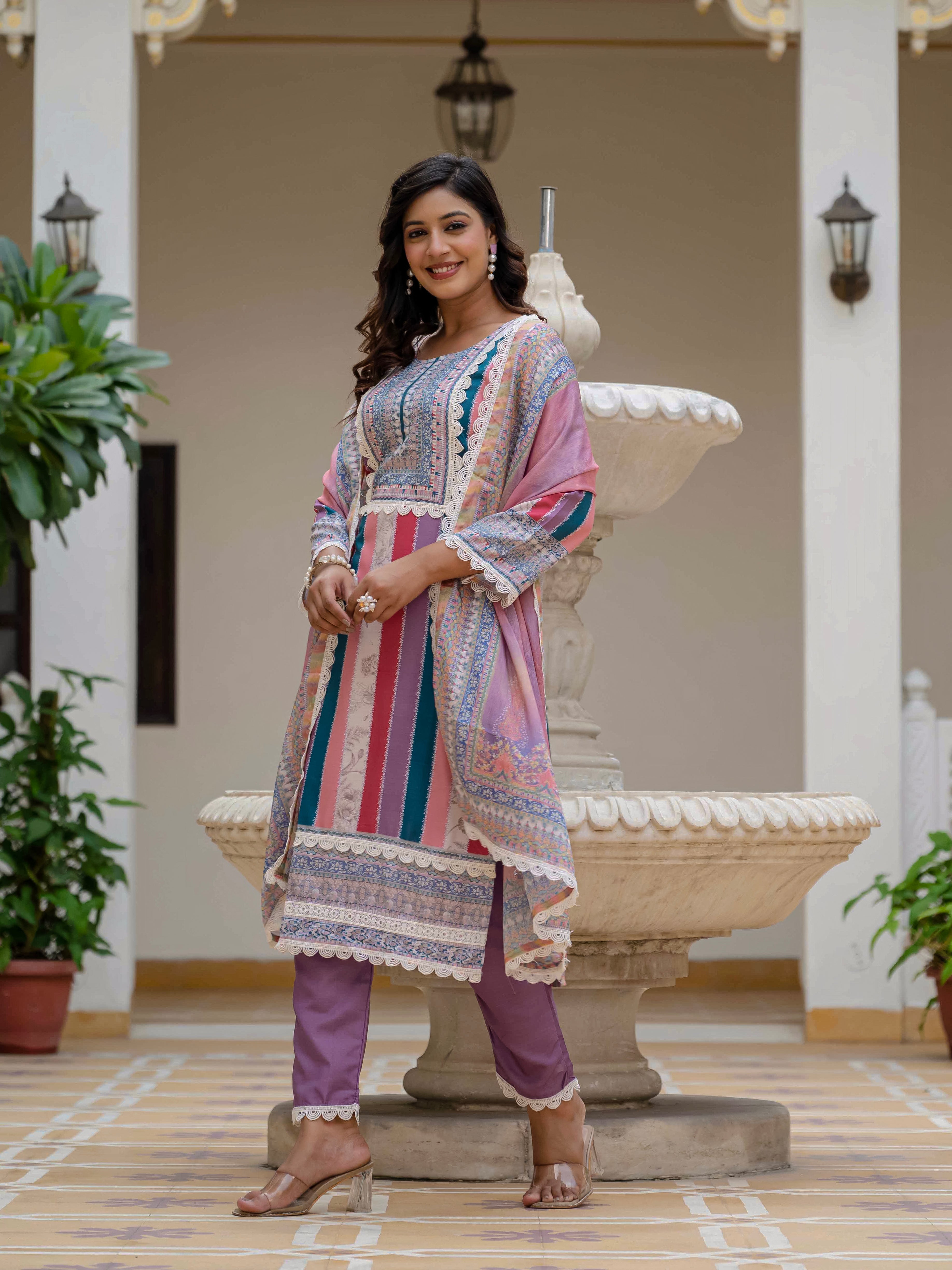 Model smiling brightly in Laila Pink Kurta Set, showcasing the full ensemble against a heritage backdrop.
