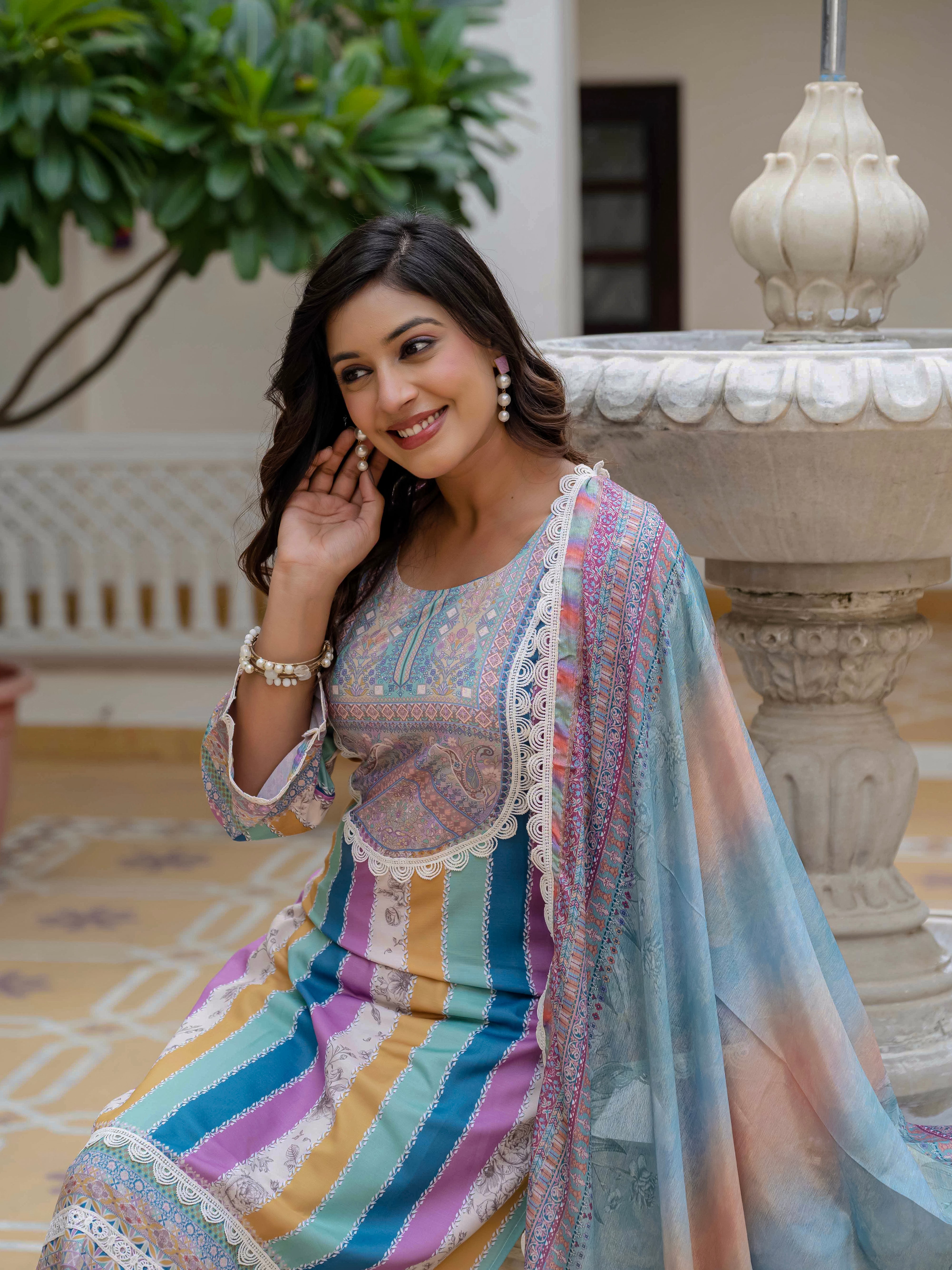 Close-up portrait of the model in Laila Sky Kurta Set, focusing on her smile and the outfit's intricate details.