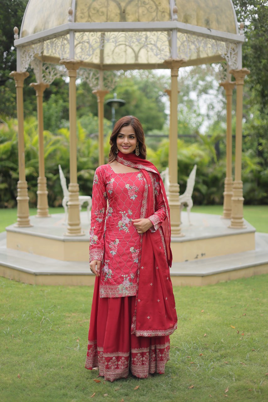 Young girl modeling a latest designer red sharara suit