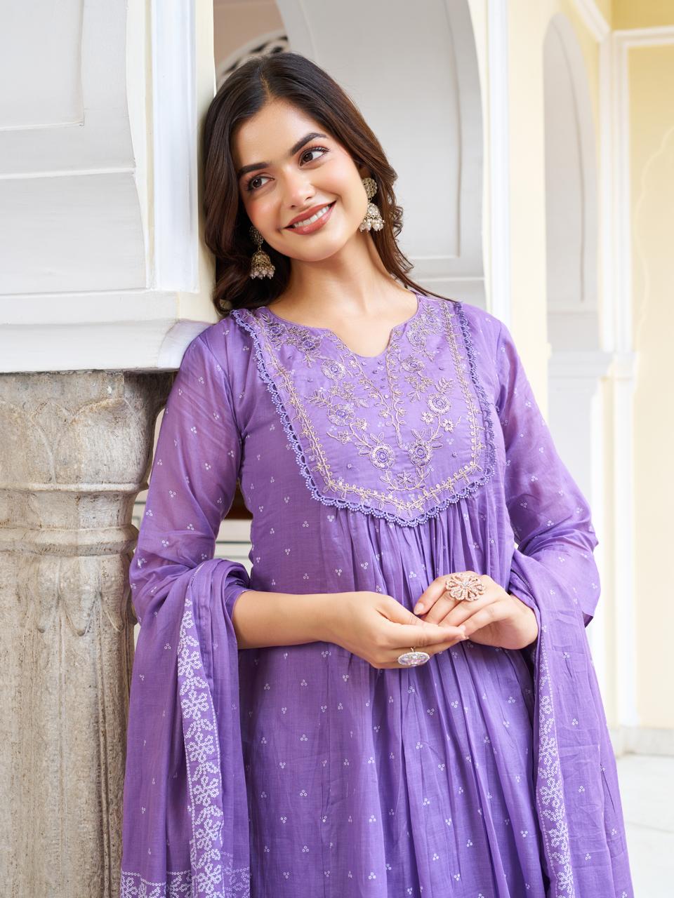 Close-up of a smiling model in a lavender kurti set, highlighting her gentle expression and the intricate embroidery on the kurti's V-neckline.