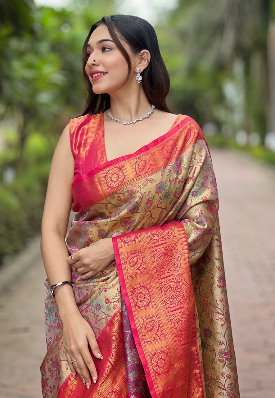 Close-up of the intricate gold zari border work on the rose gold fabric