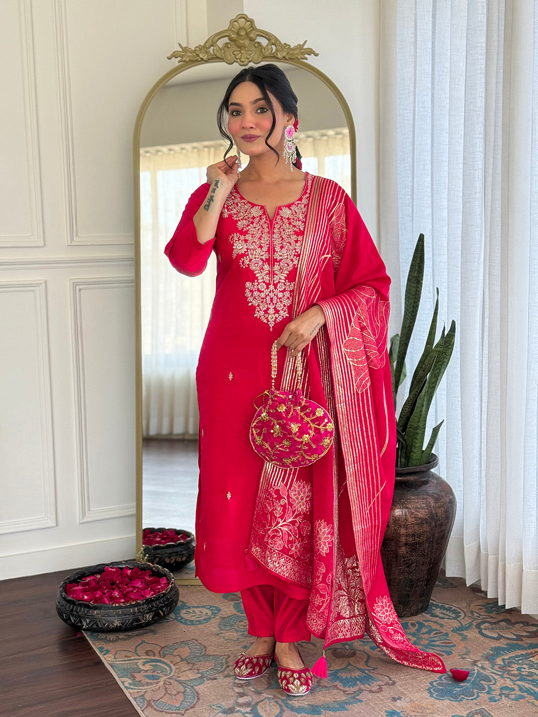 TRENDBUY model in elegant pink Roman Silk embroidered kurta set with matching potli bag and dupatta.