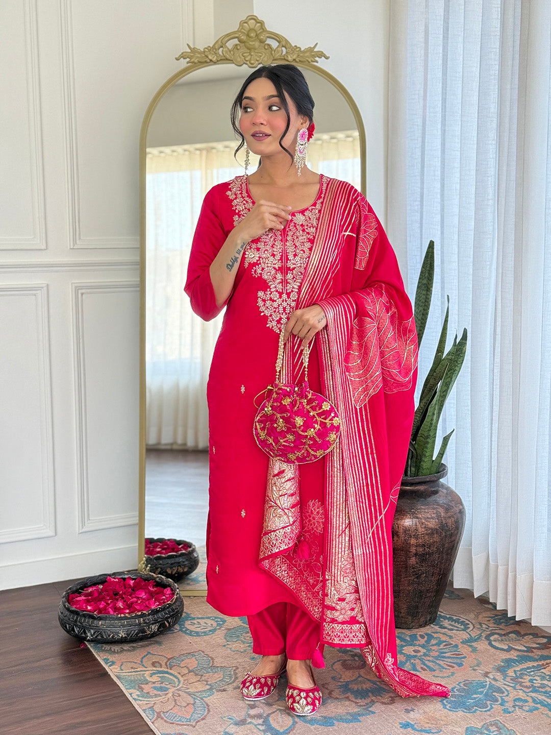 TRENDBUY model gracefully posing in the full pink Roman Silk embroidered kurta set, featuring trousers and dupatta.