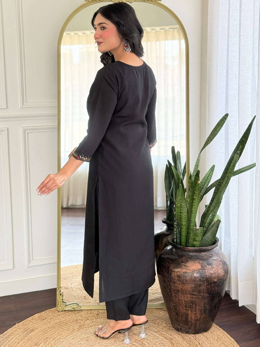 TRENDBUY VI-STREE Black Roman Silk kurti set with intricate embroidery on cuffs, seen from the side, a woman stands in front of a mirror.