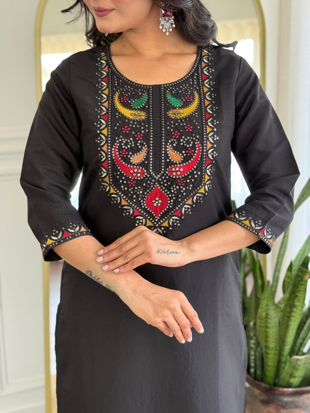 Close-up view of the TRENDBUY VI-STREE Black Roman Silk kurti, highlighting the vibrant multi-color embroidery on the round neckline and sleeves.