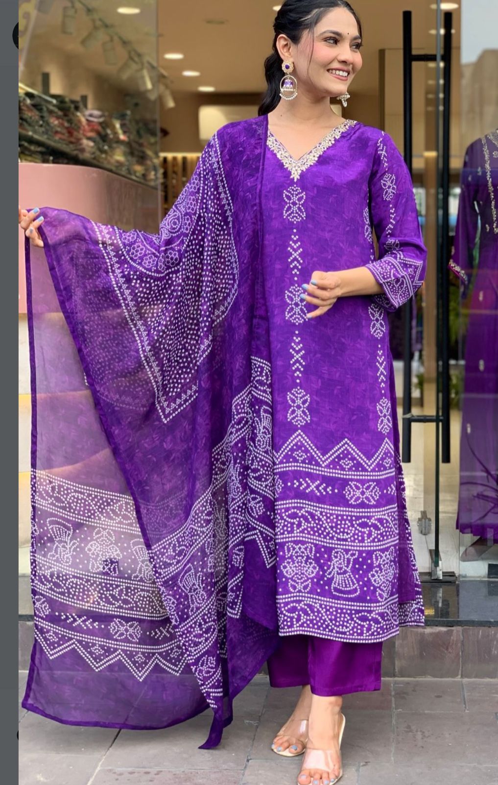 TRENDBUY woman gracefully posing in rich Purple French Crepe printed kurta set with V-neck embroidery