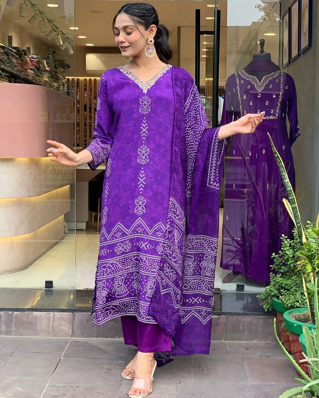 Side angle of woman posing in rich Purple French Crepe printed and embroidered kurta set