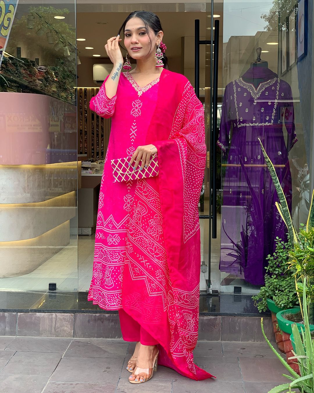 Confident TRENDBUY model in Rani Pink French Crepe kurta set, highlighting the V-neck design and print