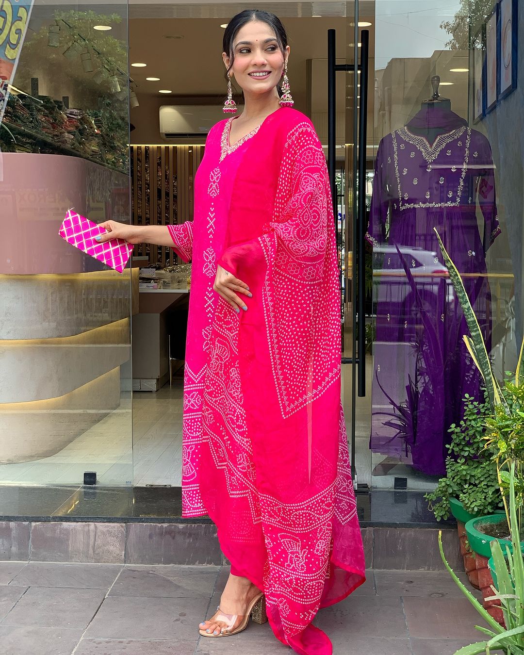 Side view of TRENDBUY woman in Rani Pink French Crepe kurta set, showcasing flowy dupatta and straight pants